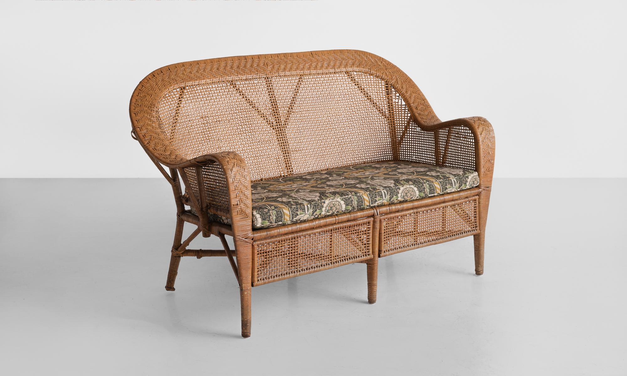 Wicket settee by Kay Fisker, circa 1950

Elegant form with ornate and varied weaving throughout, designed by Danish architect Kay Fisker. Includes a newly reupholstered seat cushion in Morris & Co. fabric.
