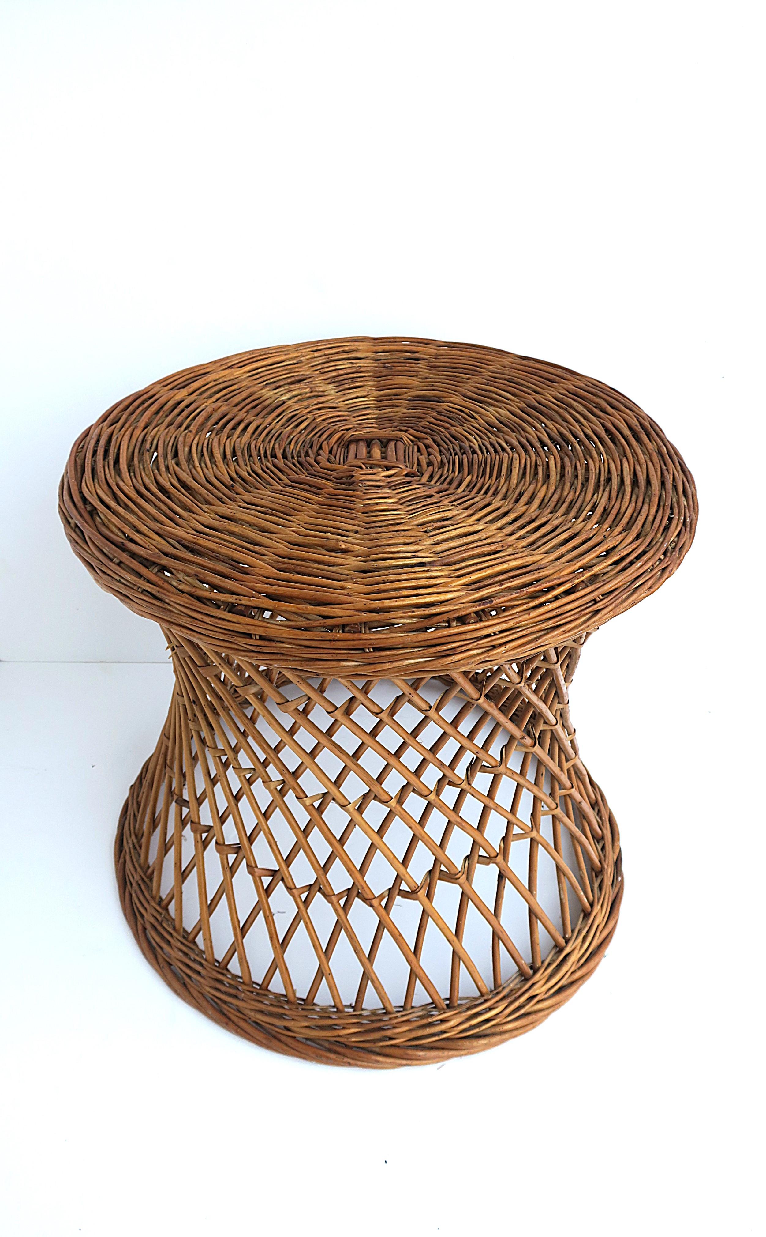A round European wicker side or end table with hourglass design, circa mid-20th century, 1960s, 1970s, Europe, Yugoslavia (now known as Slovenia) A great piece to use inside or outdoors (covered patio, etc.) Dimensions: 19.75