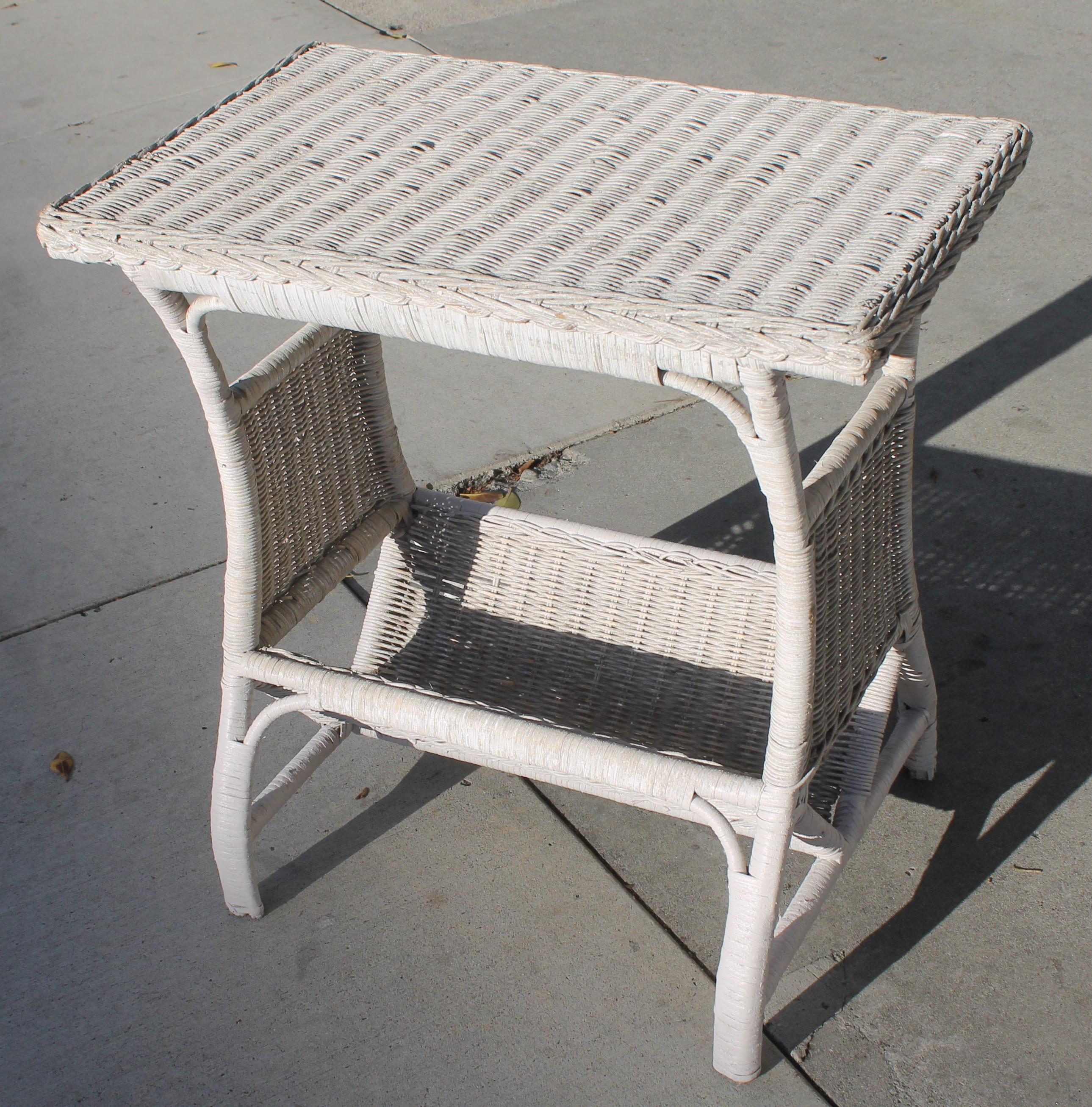 This small wicker side table is such a sweet size. It is in very good condition and has the original white painted surface.