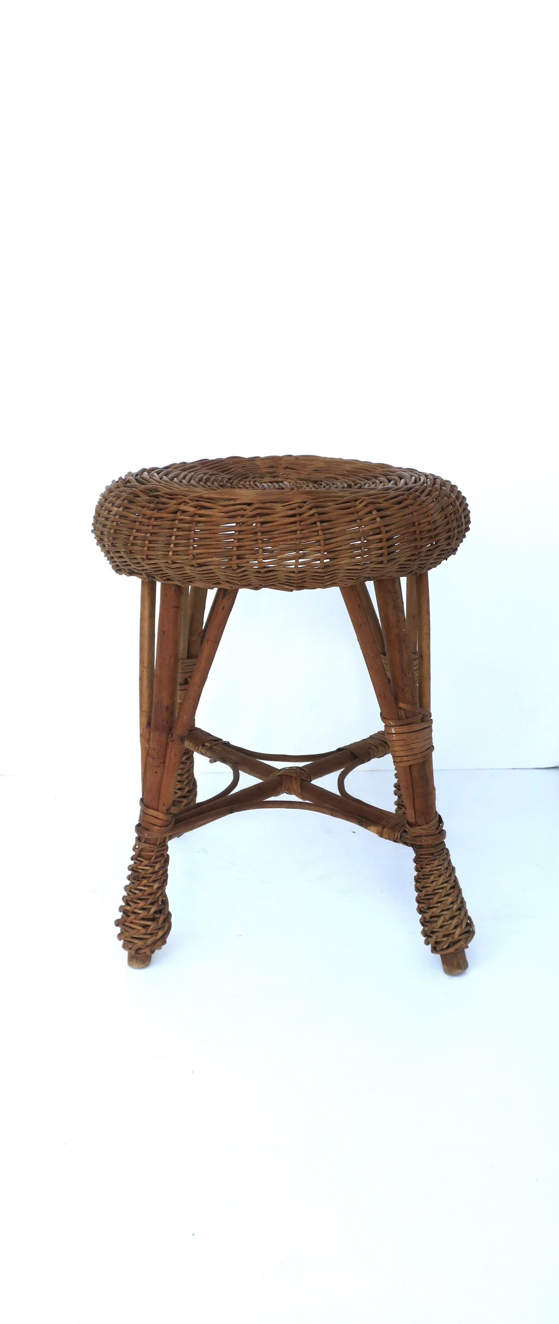 A vintage round wicker stool, circa mid-20th century. Great as a stool (it's intended use), as a drink table, a small stool/table for a bath area, to display books, plant stand, etc. Many uses. Piece works as a side/drink table providing there's a