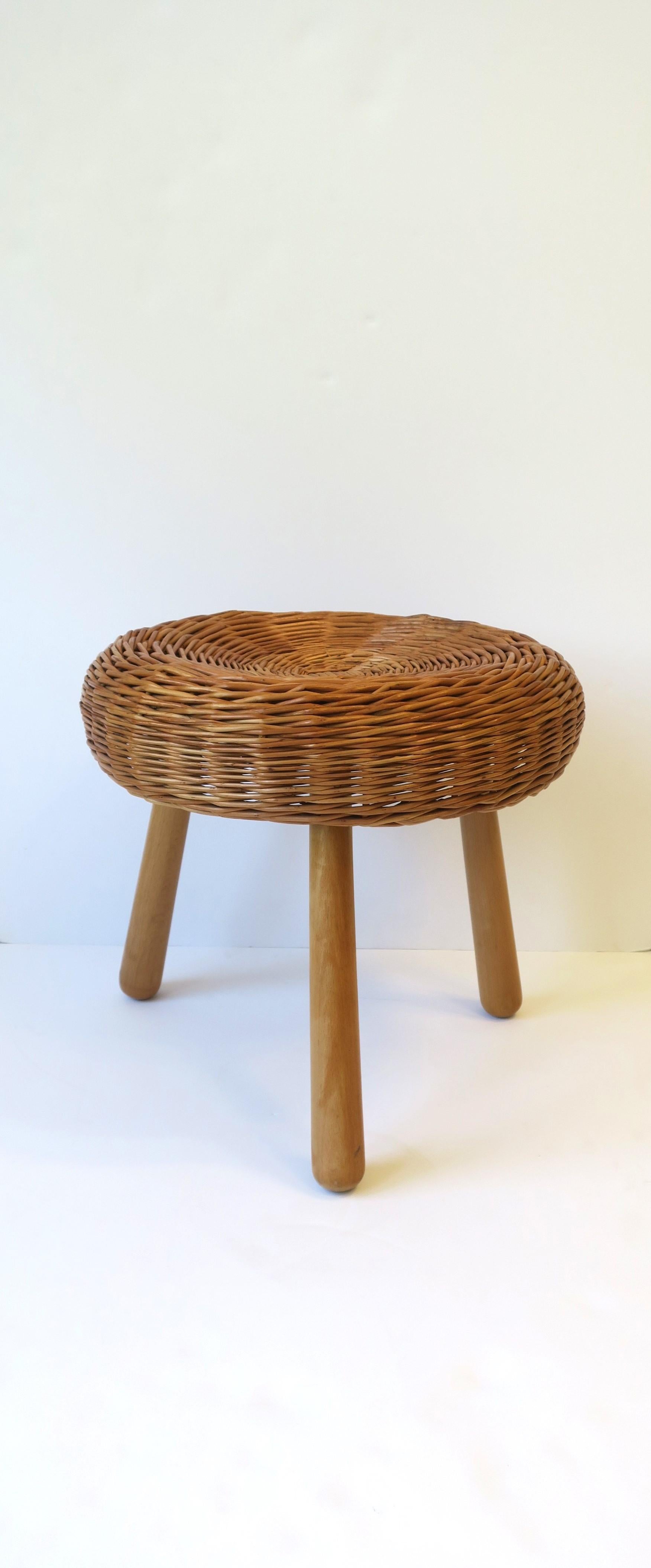 A European wicker 'tri-pod' stool, Midcentury Modern period, circa mid-20th century, Yugoslavia. A beautiful stool, footstool, or drinks table (providing there is a stable environment on top, e.g., tray, book, as demonstrated), plant stand, etc.