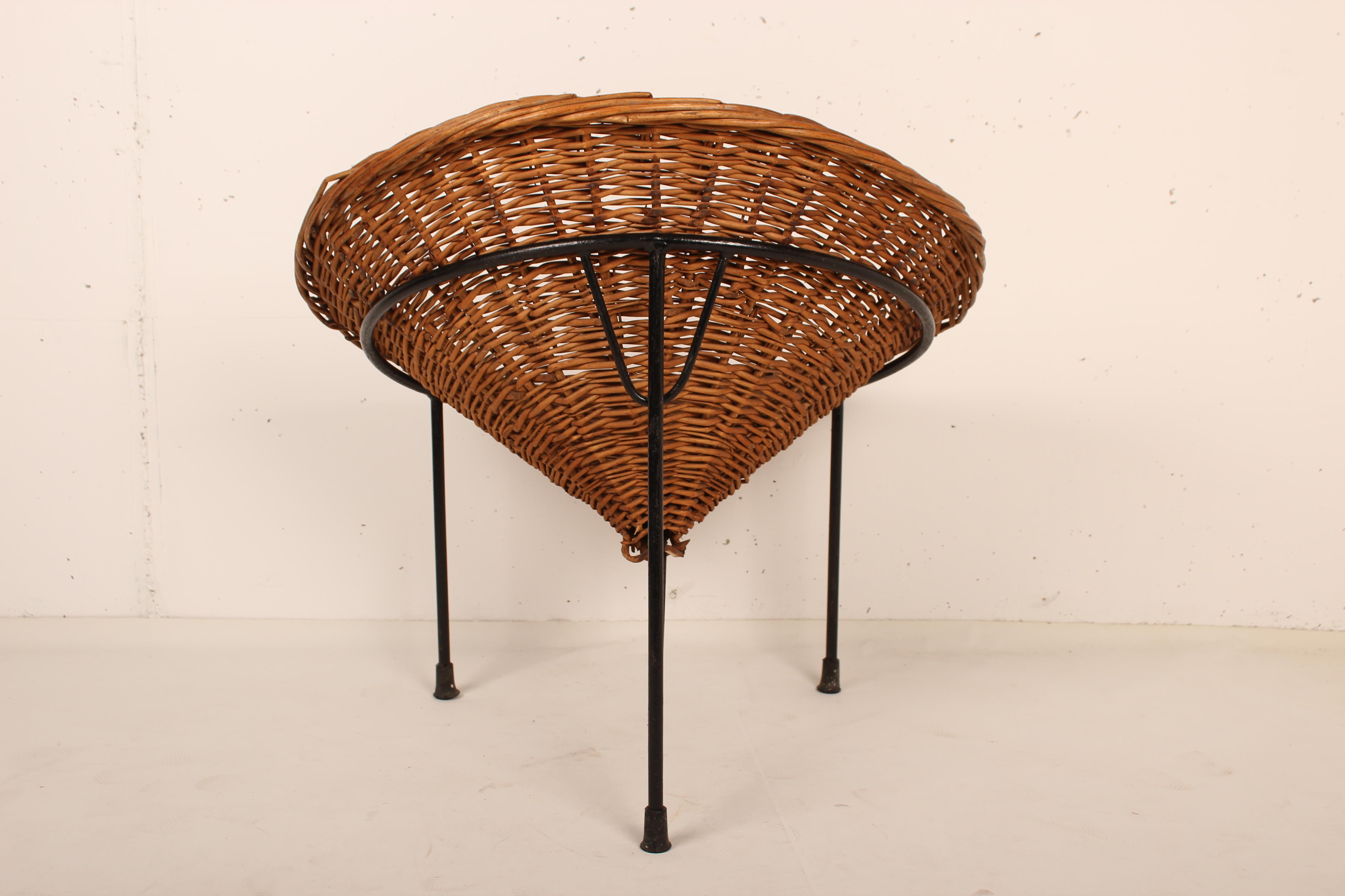 Wicker basket cone chair raised on a three legs wrought iron frame. By architect Roberto Mango for Tecno in 1954.