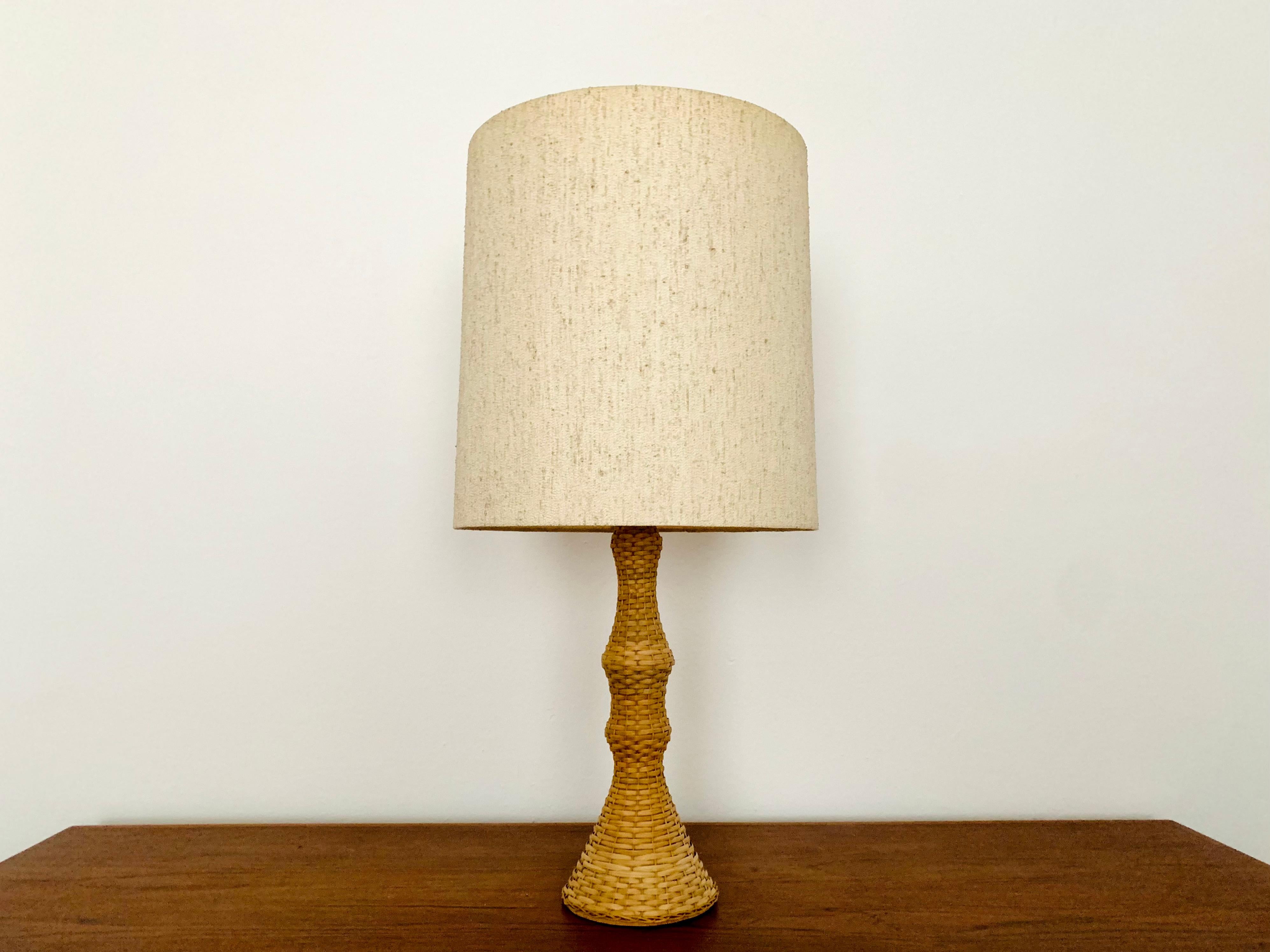 Wonderful table lamp from the 1950s.
Extraordinary design with a fantastically comfortable look.
The materials create a cozy light.

Condition:

Very good vintage condition with slight signs of wear consistent with age.
Minimal patina and
