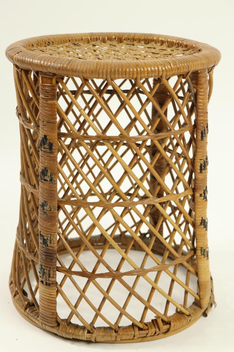 Stylish diminutive wicker taboret style table originally designed as a companion piece for the classic Emmanuelle wicker peacock chair. The small side table is not often seen, and is less common than the chair. This example is in very good overall