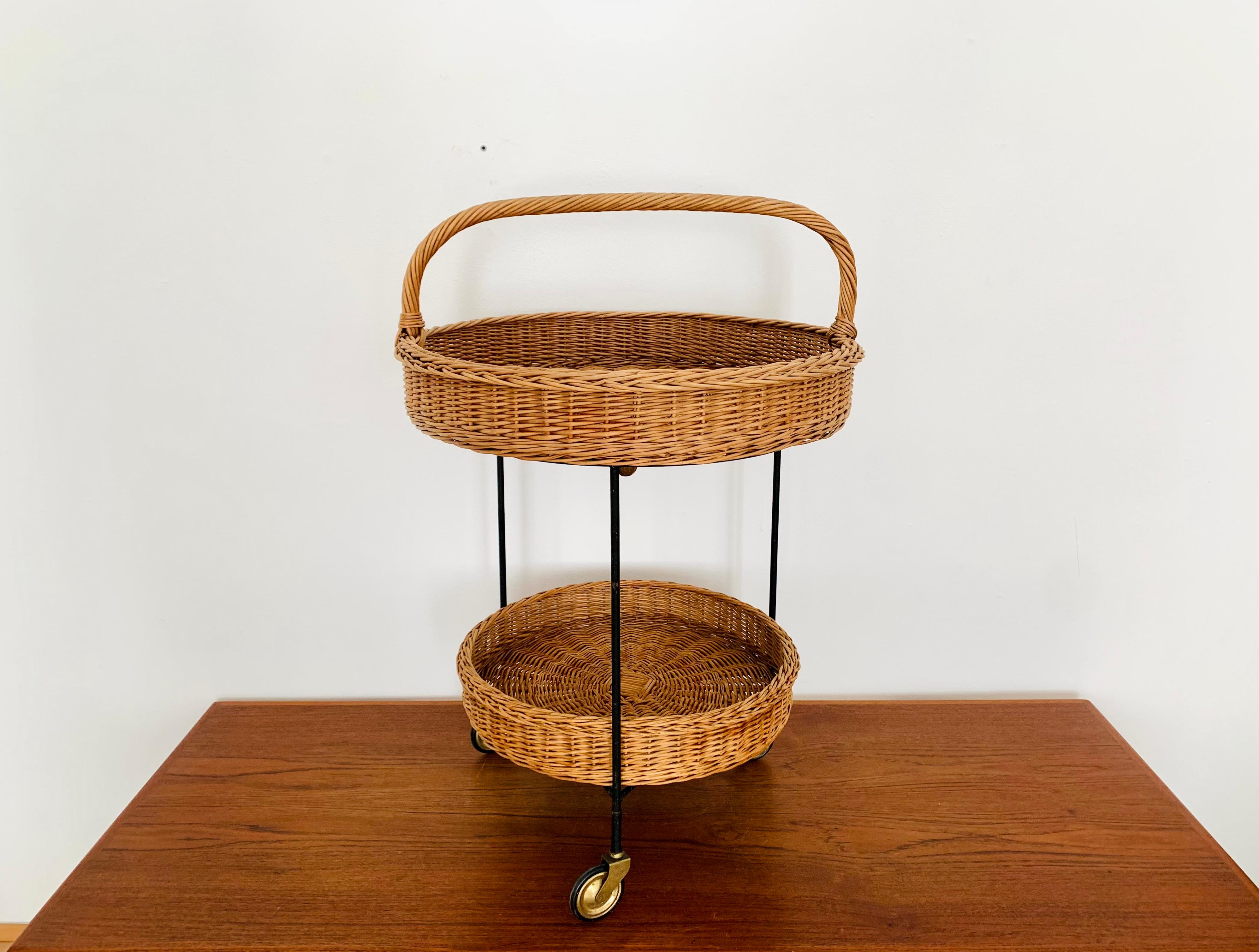 Exceptionally beautiful tea cart or bar cart from the 1950s.
Wonderful design and stable, high-quality workmanship.
The upper basket can also be used as a tray.
The handle is sturdy and makes it easy to carry.
An enrichment for every home and every