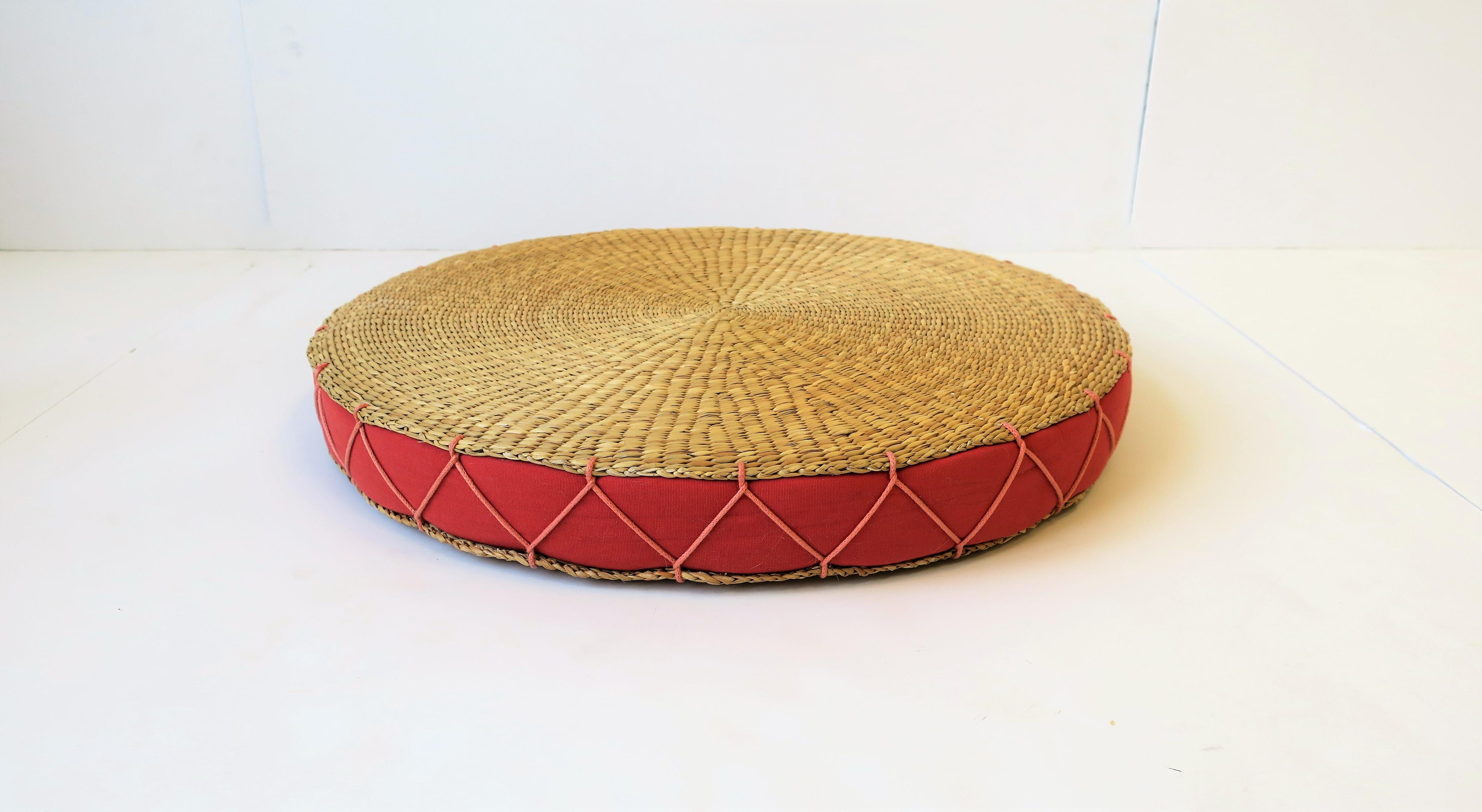 A vintage wicker tray or seat cushion with upholstered insert and large 'X' stitching around. 

Piece measures: 18 in. diameter x 2 in. height.