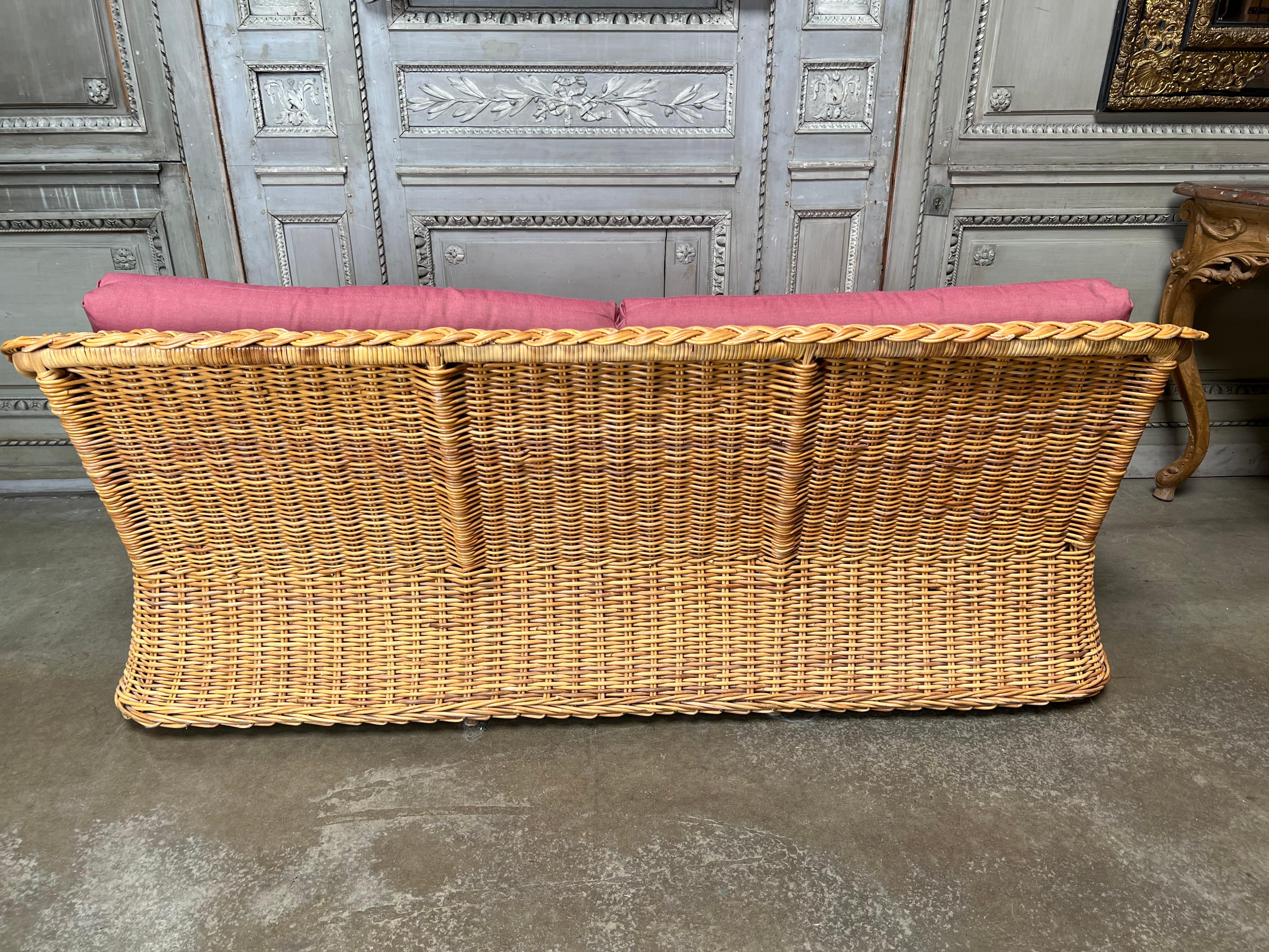 A vintage Wicker Works Sofa from the 1980's. It is a comfortable easy to use sofa that will mix well with almost anything. This sofa does have a few flaws on the wicker and the fabric is fresh and usable but is used. 
This sofa has a pair of