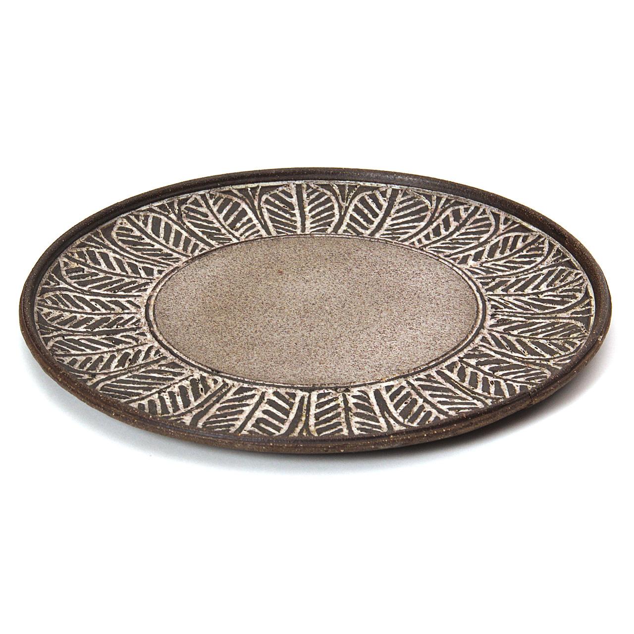 A hand-thrown earthenware ceramic platter with incised leaf motif and stone gray glaze. Signed 