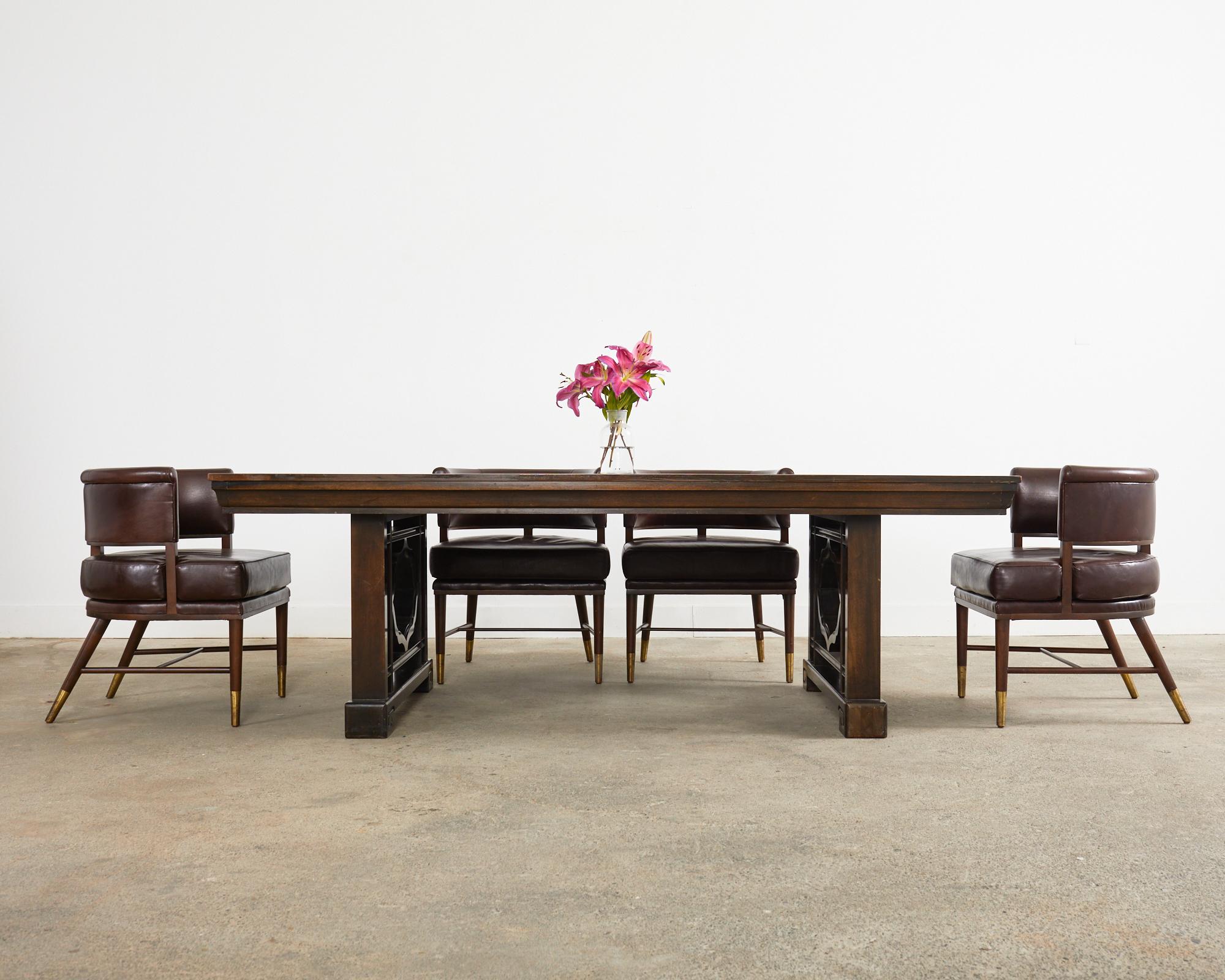 Grand mid-century modern mahogany dining table with two extending leaves measuring 24 inches each. Rare table produced by John Widdicomb with its Asian inspired design attributed to T.H Robsjohn Gibbings. The table top measures 88 inches closed and