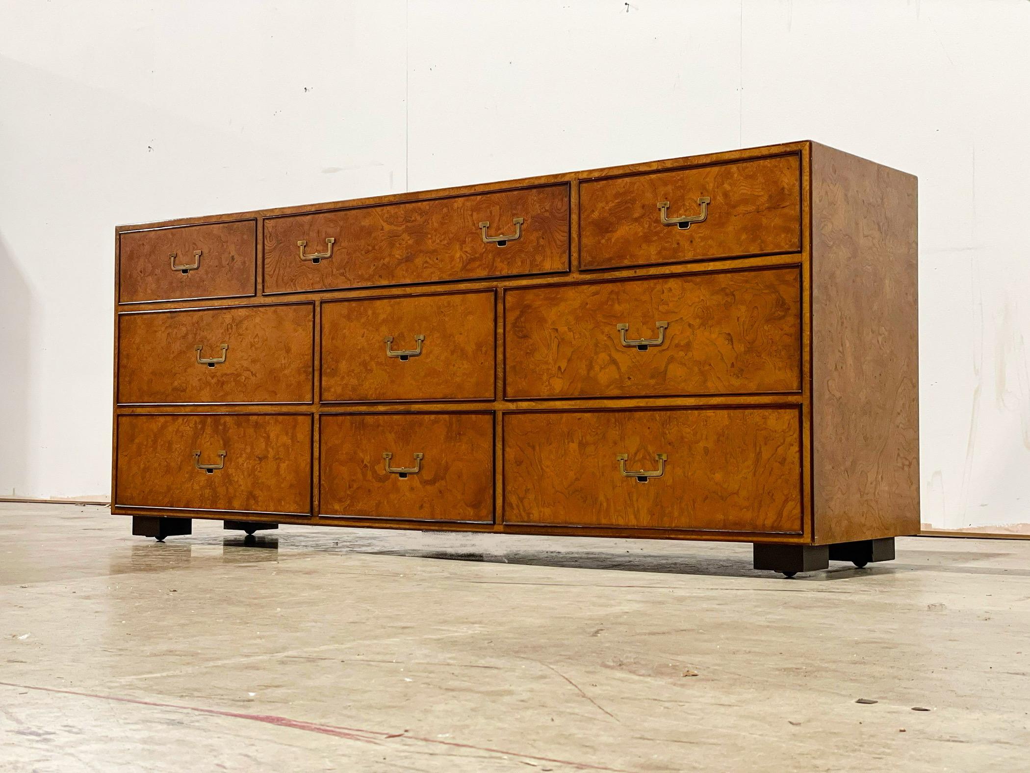 Rare nine drawer burled olivewood campaign dresser by John Widdicomb. Classic and timeless design with unparalleled American craftsmanship. 
Recessed ebonized legs have built in casters.
Excellent original condition, looks to have been hardly, if