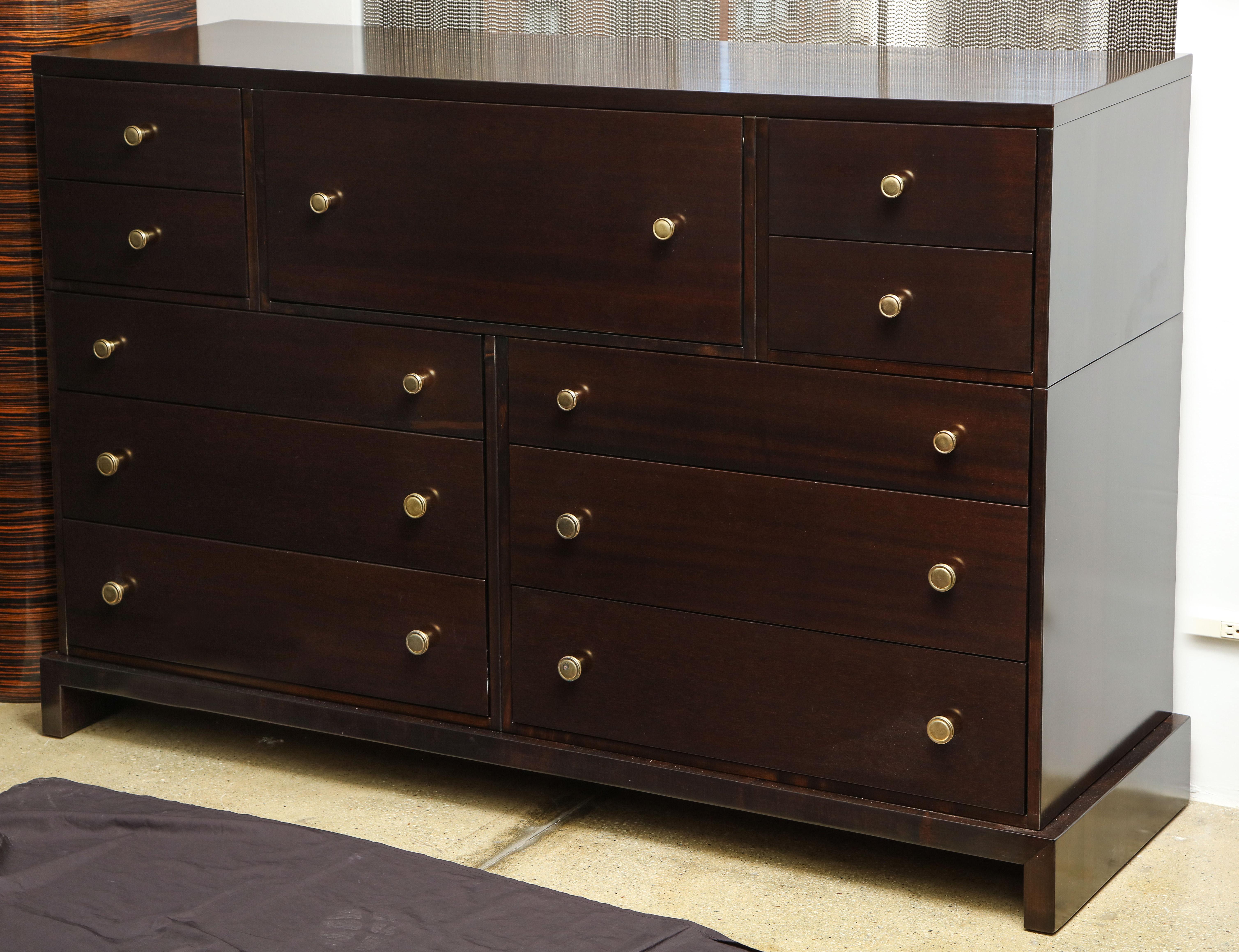 Impressive scale midcentury double dresser with brass button knobs. Cabinet features ample storage and has a center secretary compartment with a drop front which conceals shelves and drawers. Attributed to Robsjohn-Gibbings. Mint restored in a
