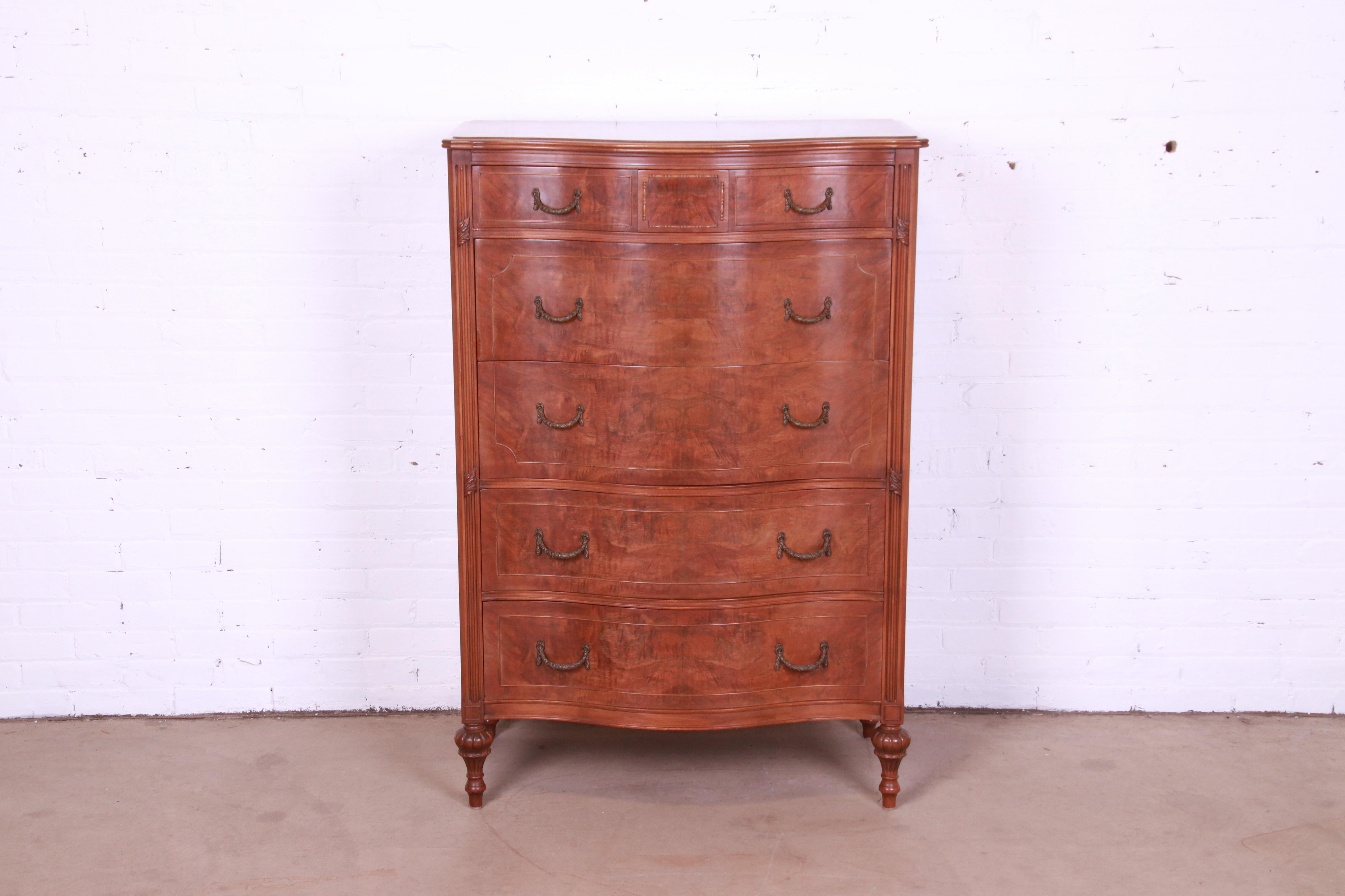 An exceptional French Regency Louis XVI style bow front highboy dresser

By Widdicomb

USA, Circa 1920s

Gorgeous figural burled walnut, with original brass hardware.

Measures: 35