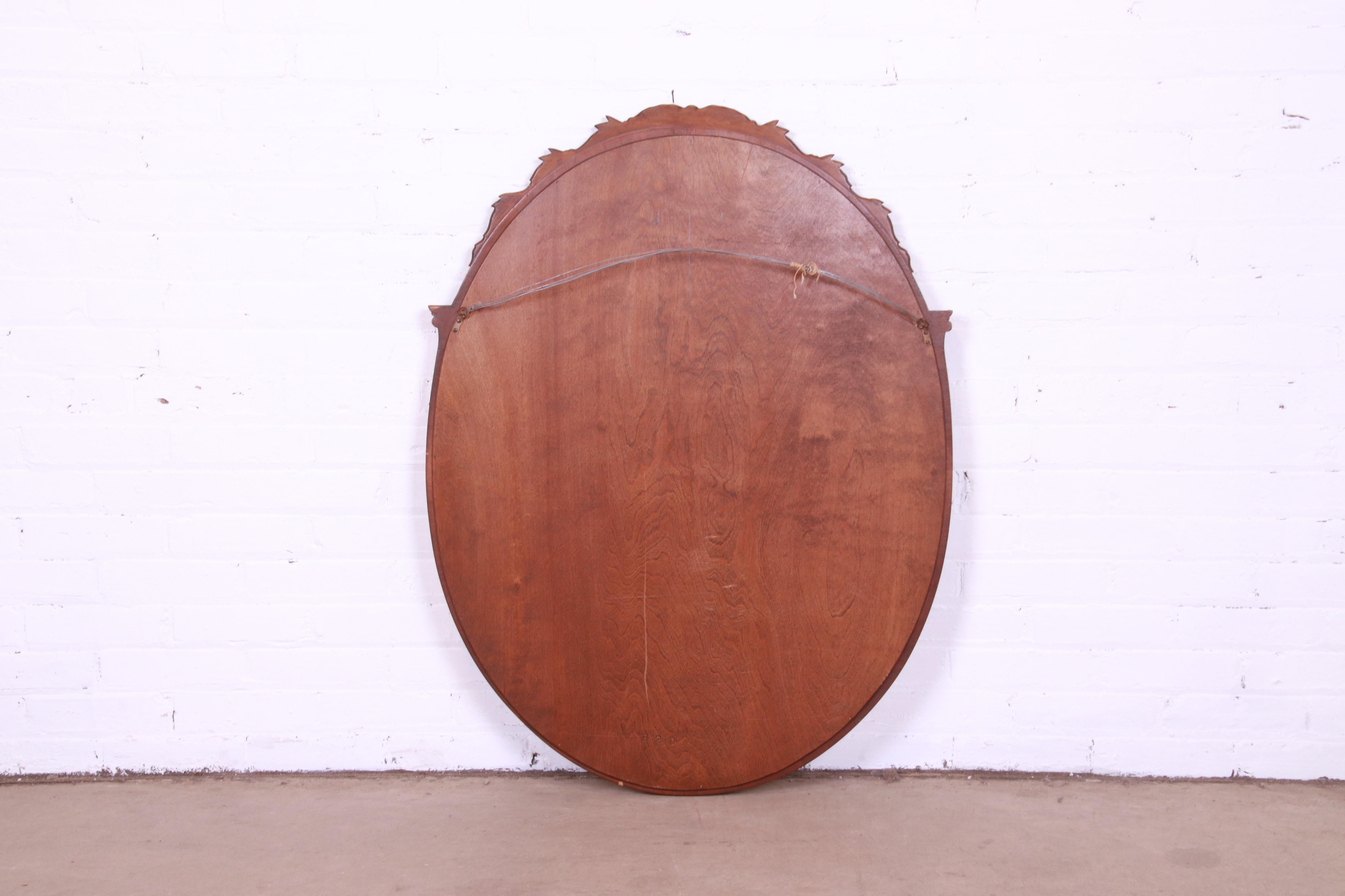 20th Century Widdicomb French Regency Louis XVI Carved Walnut Oval Wall Mirror, Circa 1920s For Sale