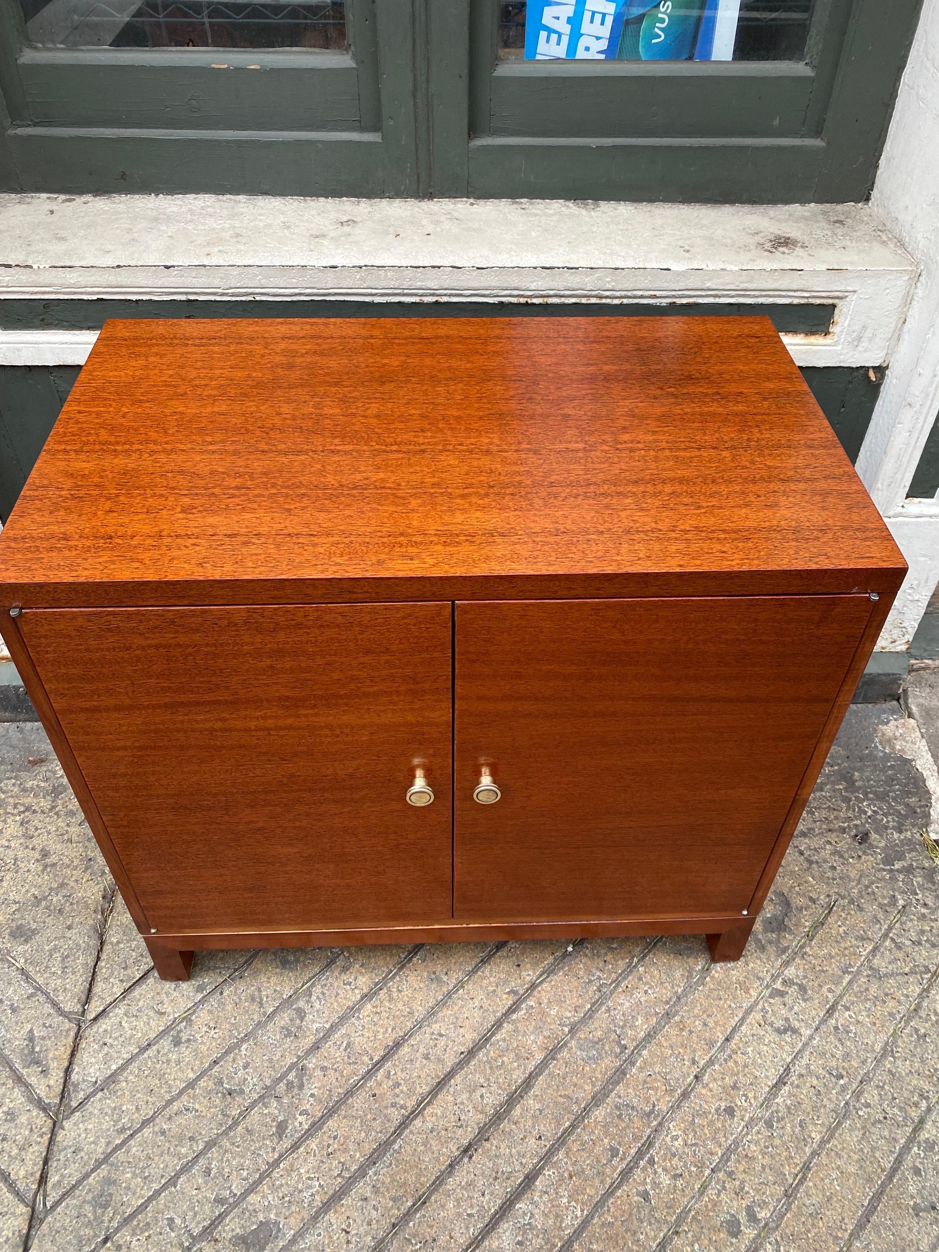 Widdicomb modern 2 door mahogany cabinet. 2 doors open to adjustable shelves. Newly refinished with original brass pulls polished! Great size perfect to use in many places in the home! Perfect as a bar cabinet or to hold a Stereo or records!