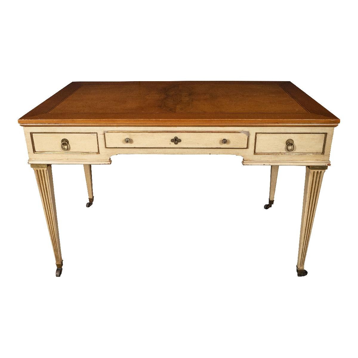 Carved, painted and giltwood Hollywood Regency style desk on brass castors with walnut burl top by Berkey Furniture Co. for John Widdicomb. Signed.