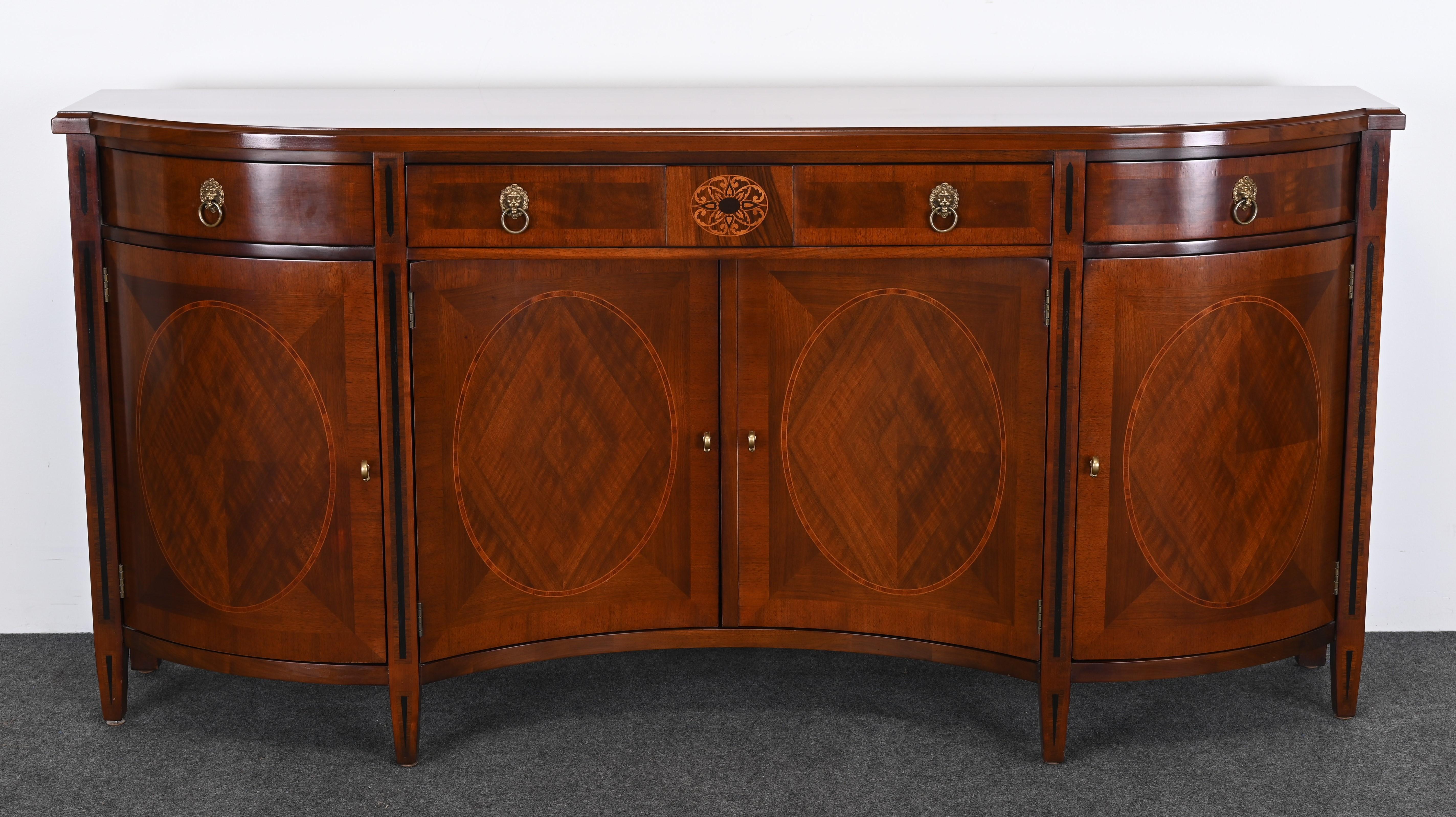 A beautiful Neoclassical sideboard or credenza made by John Widdicomb Furniture Company. This handsome sideboard is made of walnut with fine fruitwood, ebony, and mahogany inlays in the decoration. This piece retailed for $16,000. The functionality