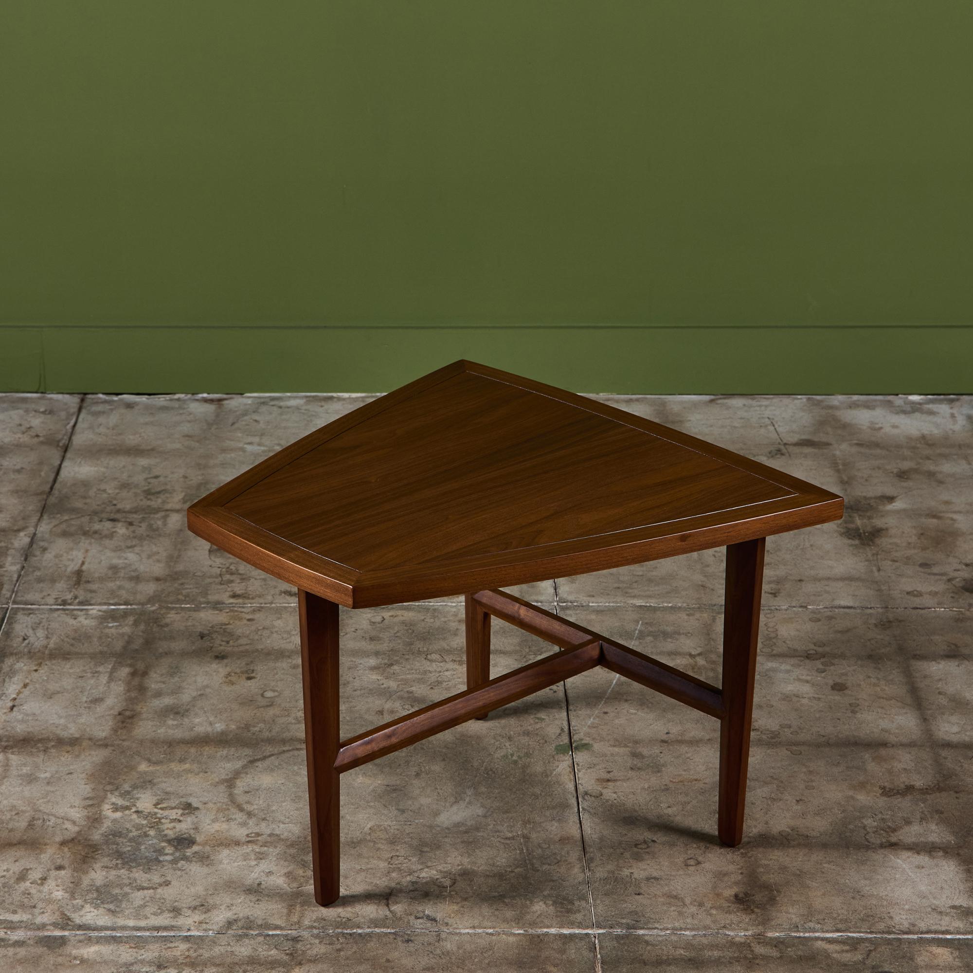 Walnut side table by Grand Rapids, Michigan-based Widdicomb, c.1950s. The table features trapezoid table top with faceted tapered legs and faceted stretchers. This design is similar to tables that George Nakashima did for his 