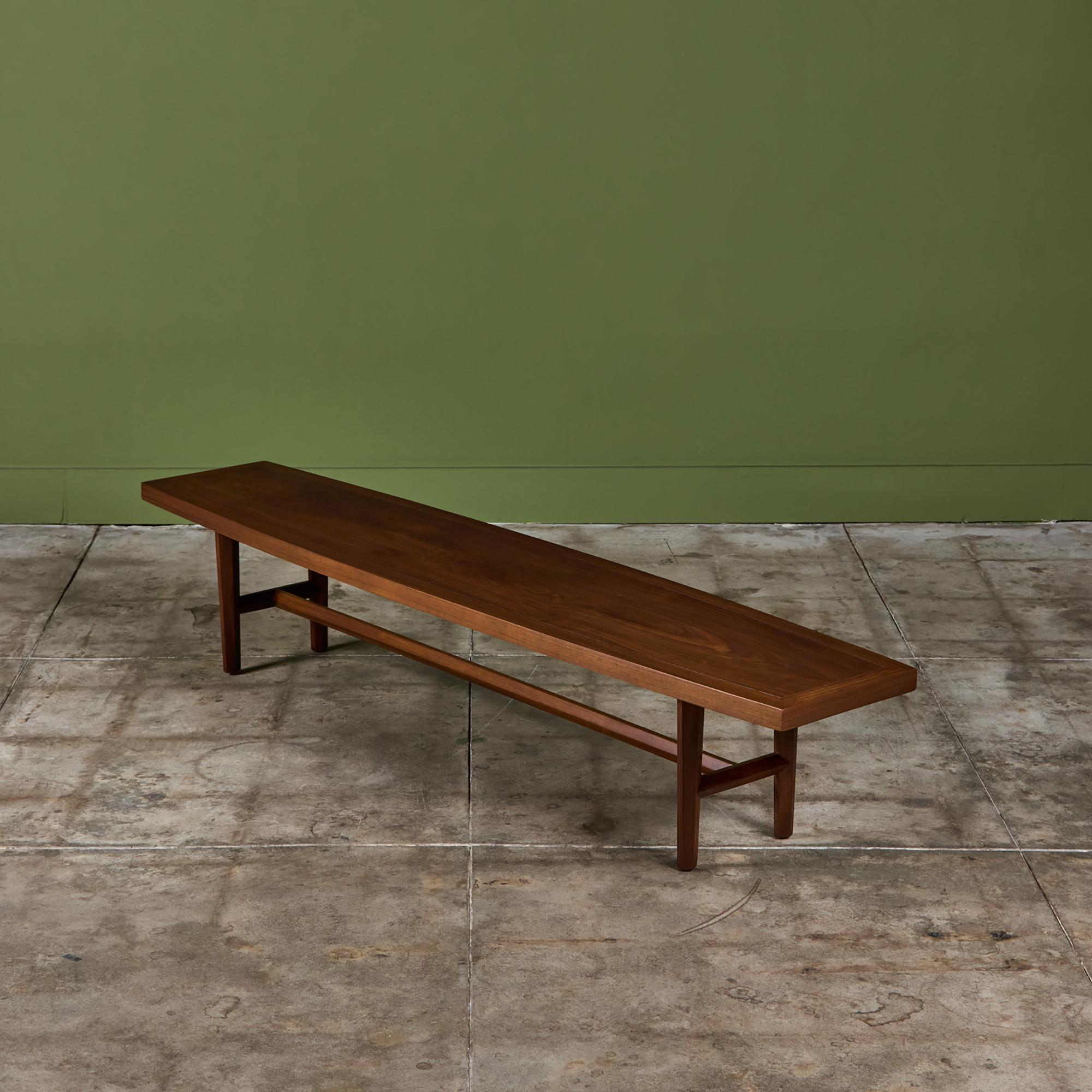 Walnut coffee table by Grand Rapids, Michigan-based Widdicomb, c.1950s. The table features a flared rectangular top on faceted tapered legs and faceted stretchers on the length and width. This design is similar to tables that George Nakashima did