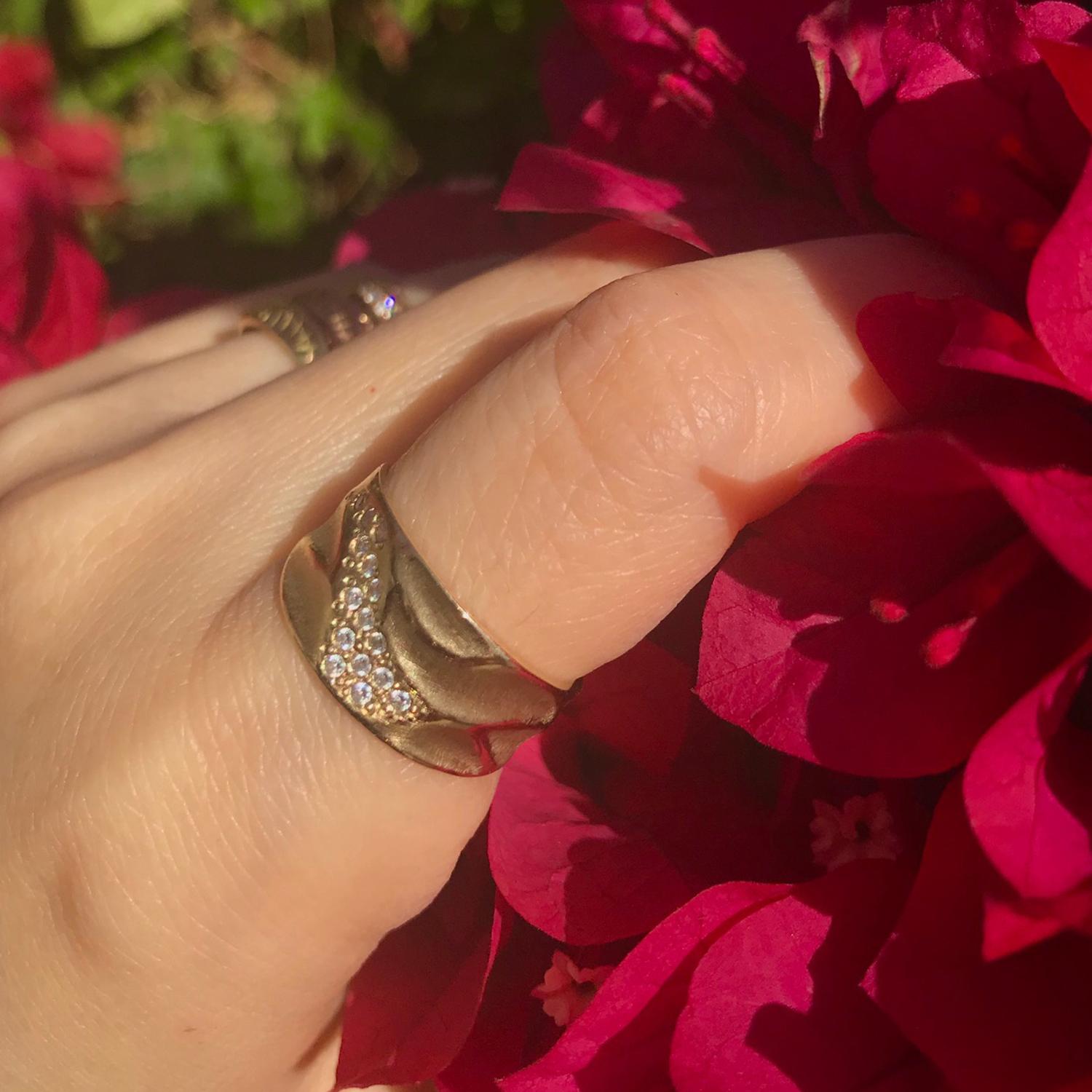 K.Mita's Wide Dune Ring has her signature Sand Dune wave and texture. It is handmade from 14 Karat Yellow Gold and 10 mm width tapered to 5 mm with  0.14 Carats white diamonds. Please allow 10-14 days for delivery as each piece is made to order.