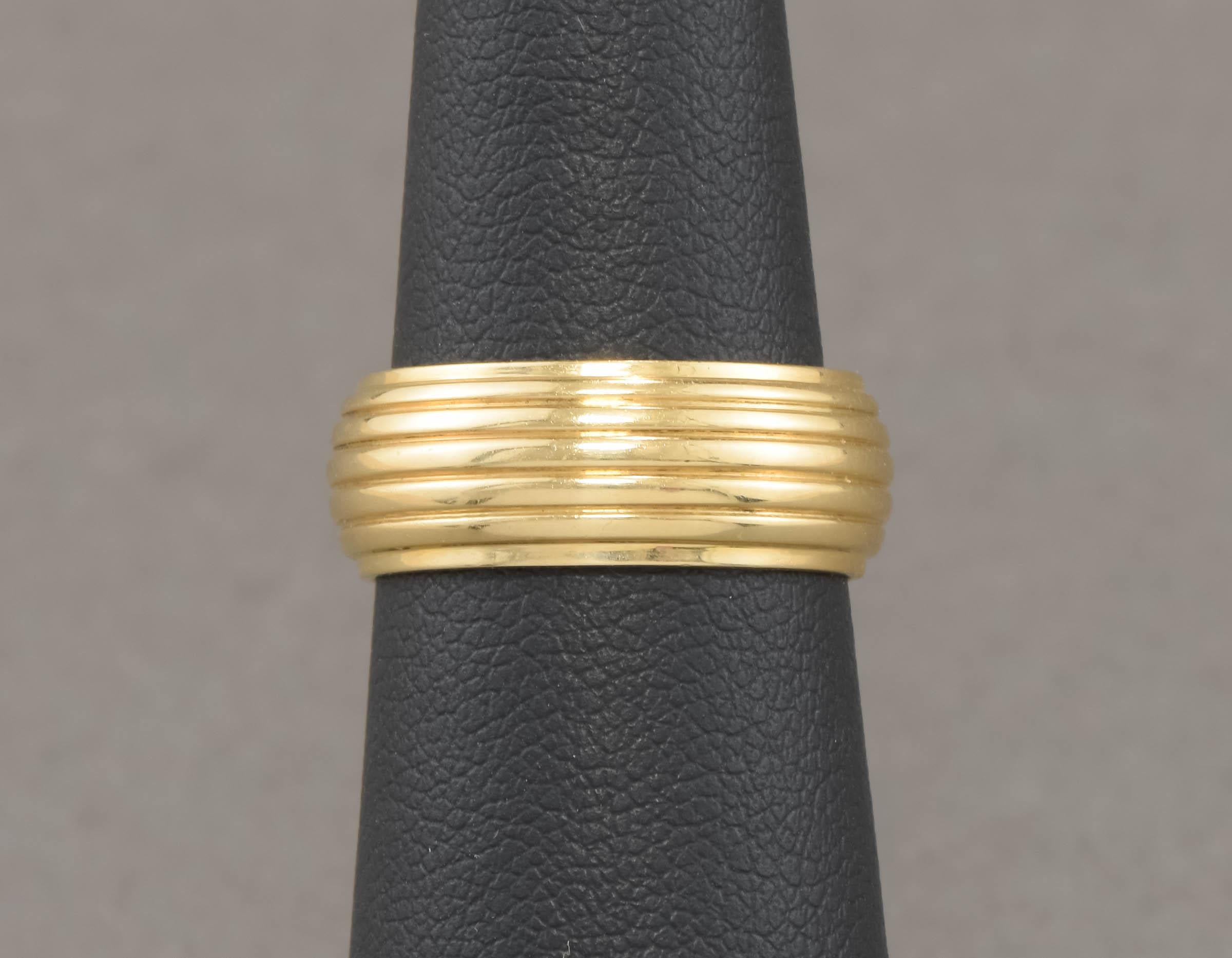 Streamlined and substantial, this vintage gold wedding band also makes a fabulous, chunky stacking ring.

Solid 14K yellow gold and approximately 7.46 mm wide, the band has a pleasingly tactile ribbed design, with a slightly domed profile.  The