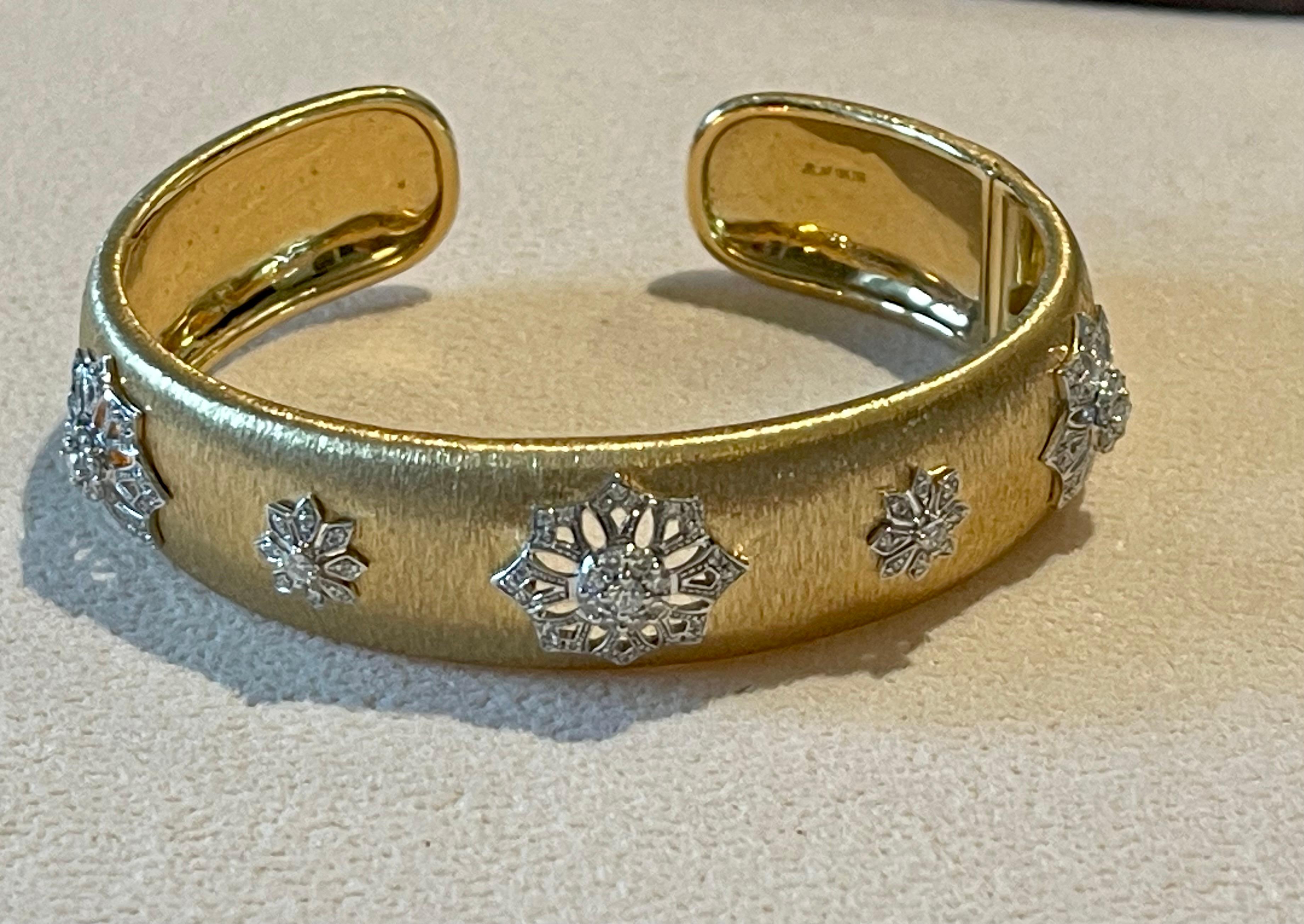 Featuirng a stunning open cuff silhouette in textured 18 K yellow  and white Gold .
This 15 mm wide cuff bracelet is made in 18 karats yellow and white gold and engraved using the sophisticated and elaborate engraving technique called ‘Rigato’ for a