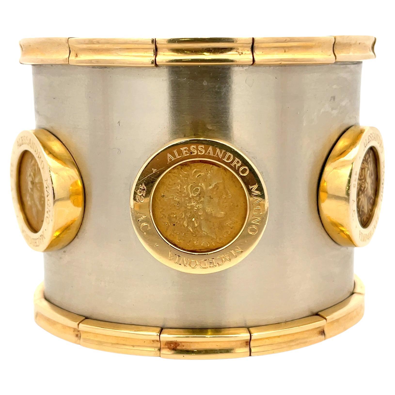 Very wide cuff bracelet featuring three coins inscribed Alessandro Magno Macedonia 432 AC on a brushed white gold bangle with yellow gold bar accents, 18 Karat, 202 Grams. 
100% Showstopper & a great conversation piece. 
DM for more videos and