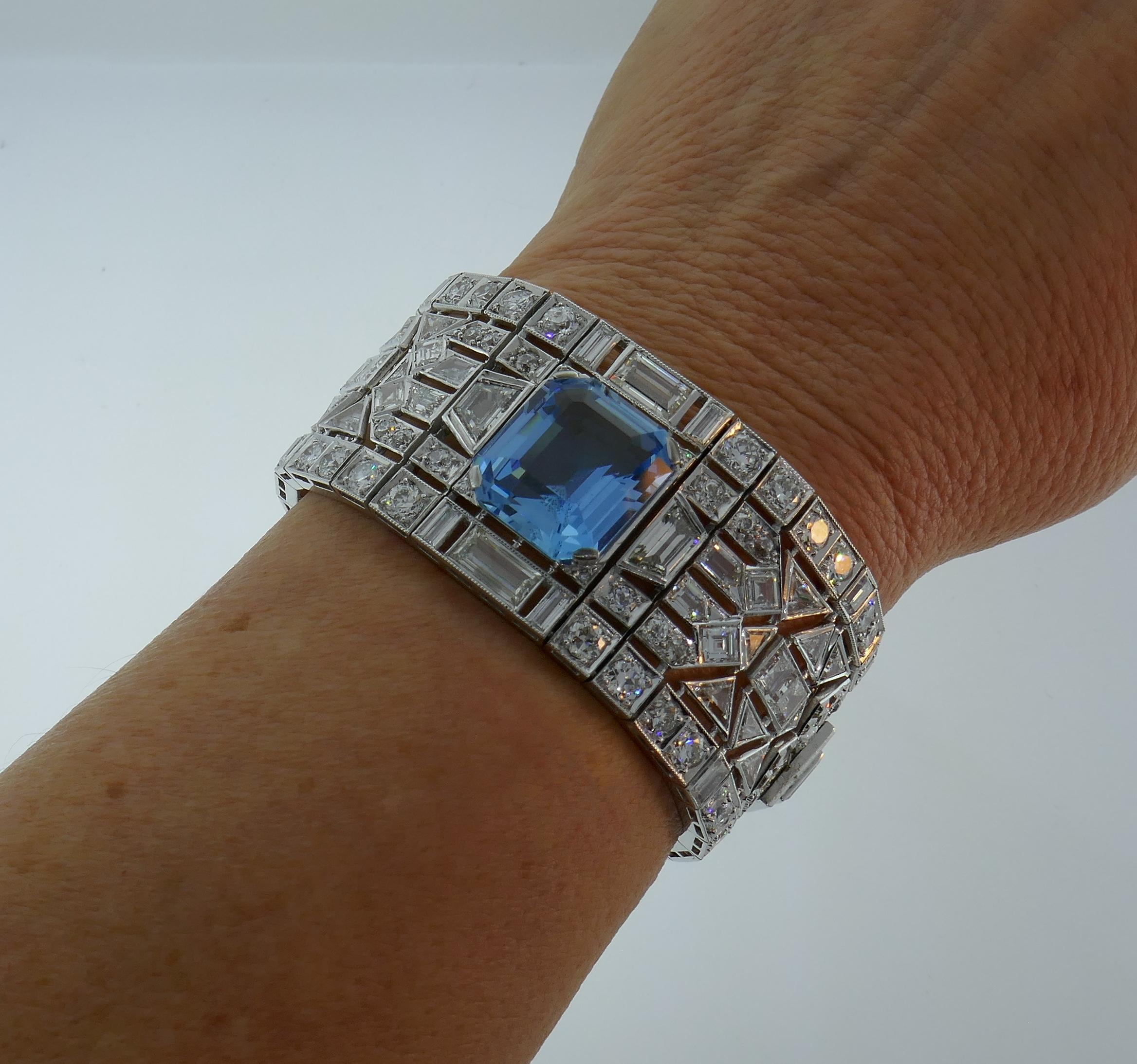 Gorgeous Art Deco Revival bracelet created in the 1960's. It features an approximately 15.47-ct emerald cut aquamarine and approximately 54.50 carats of various cuts of diamonds - old European, asscher, emerald, baguette, triangle, trapezoid,
