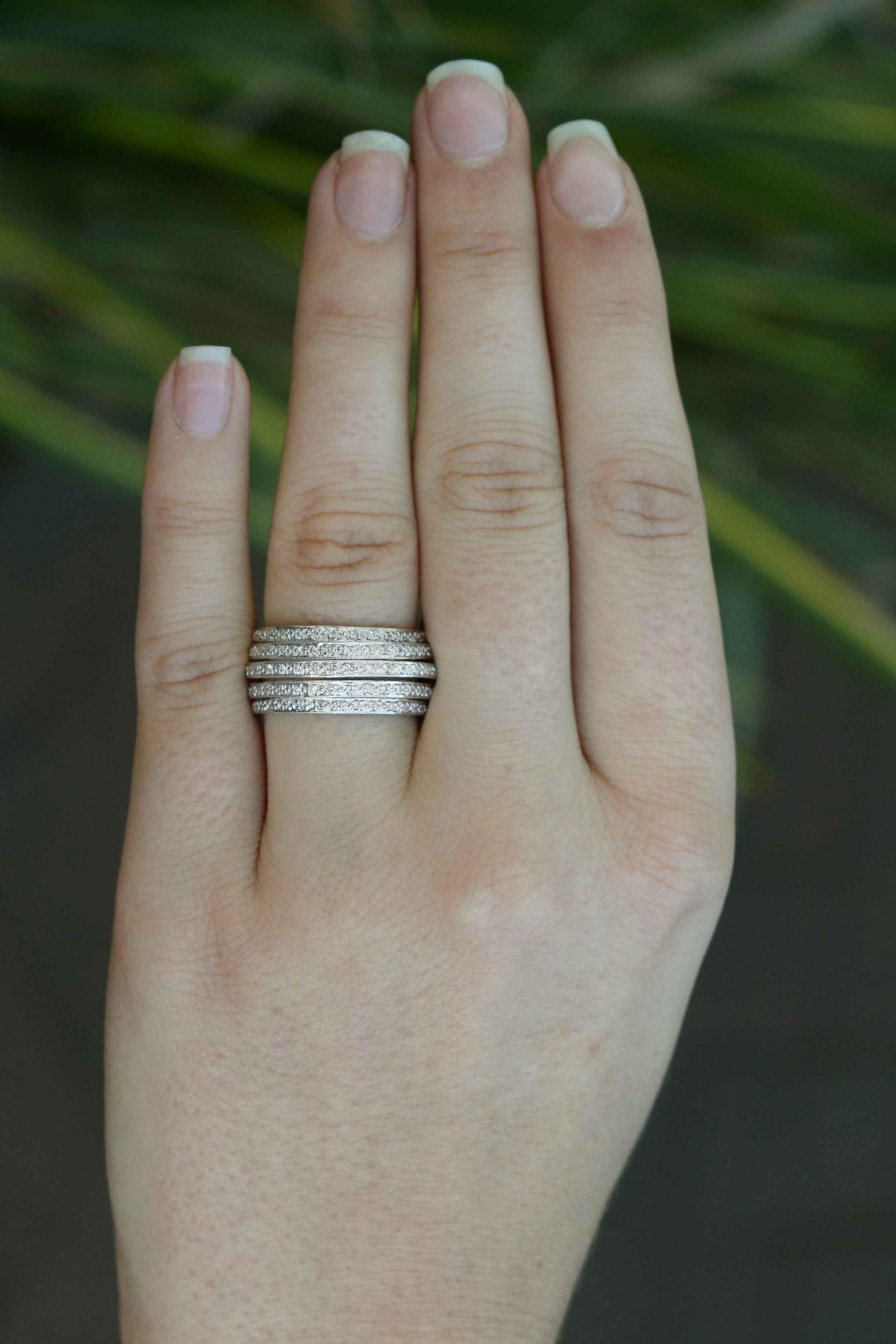 A glamorous 5-row diamond cigar band anniversary ring that makes a bold statement. The tiered rows give this ring height and presence, showing off the diamonds beautifully. We love this ring for its versatility which can be worn as a statement piece