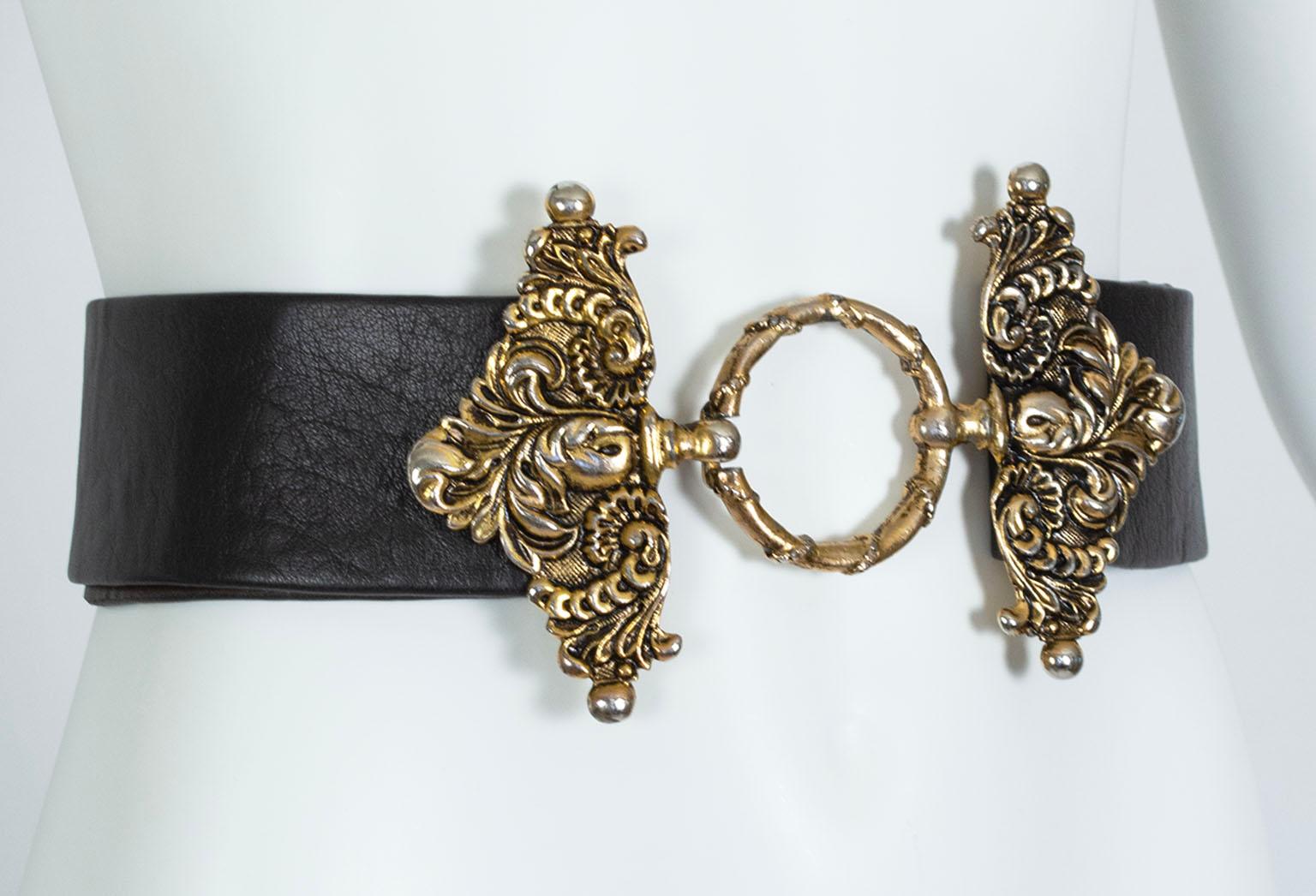 Guaranteed to be the focal point of any outfit, this belt is a hybrid of a traditional wide belt and a waist cincher thanks to its oversized scrolling gold buckle. Featuring two gold triangles with Rococo relief, the buckle clasps invisibly around a