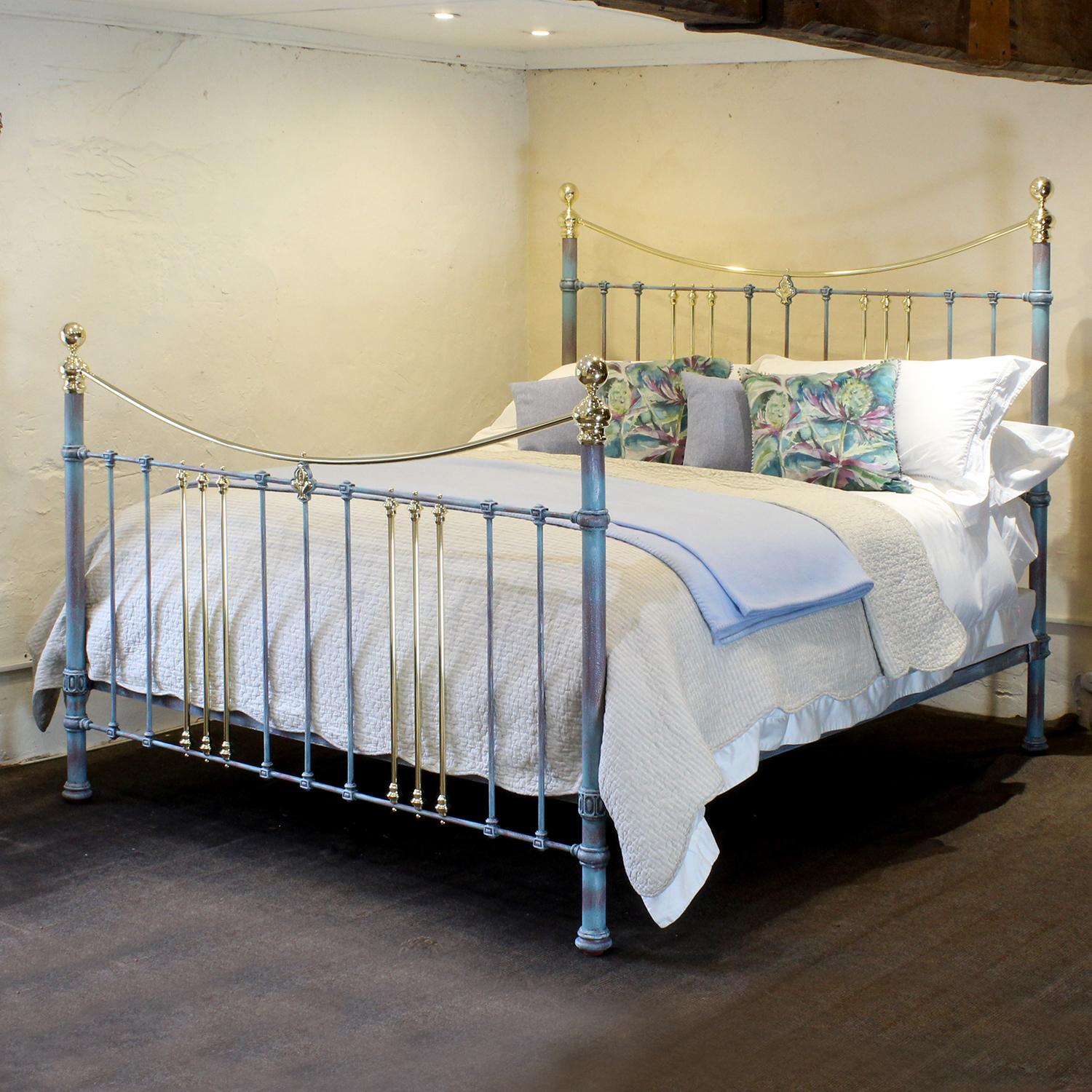 Cast iron and brass bed finished in blue verdigris with curved brass top rails and central brass rosette decoration. This bed has been expertly restored and extended from an original Victorian frame, circa 1890, and hand painted in one of our