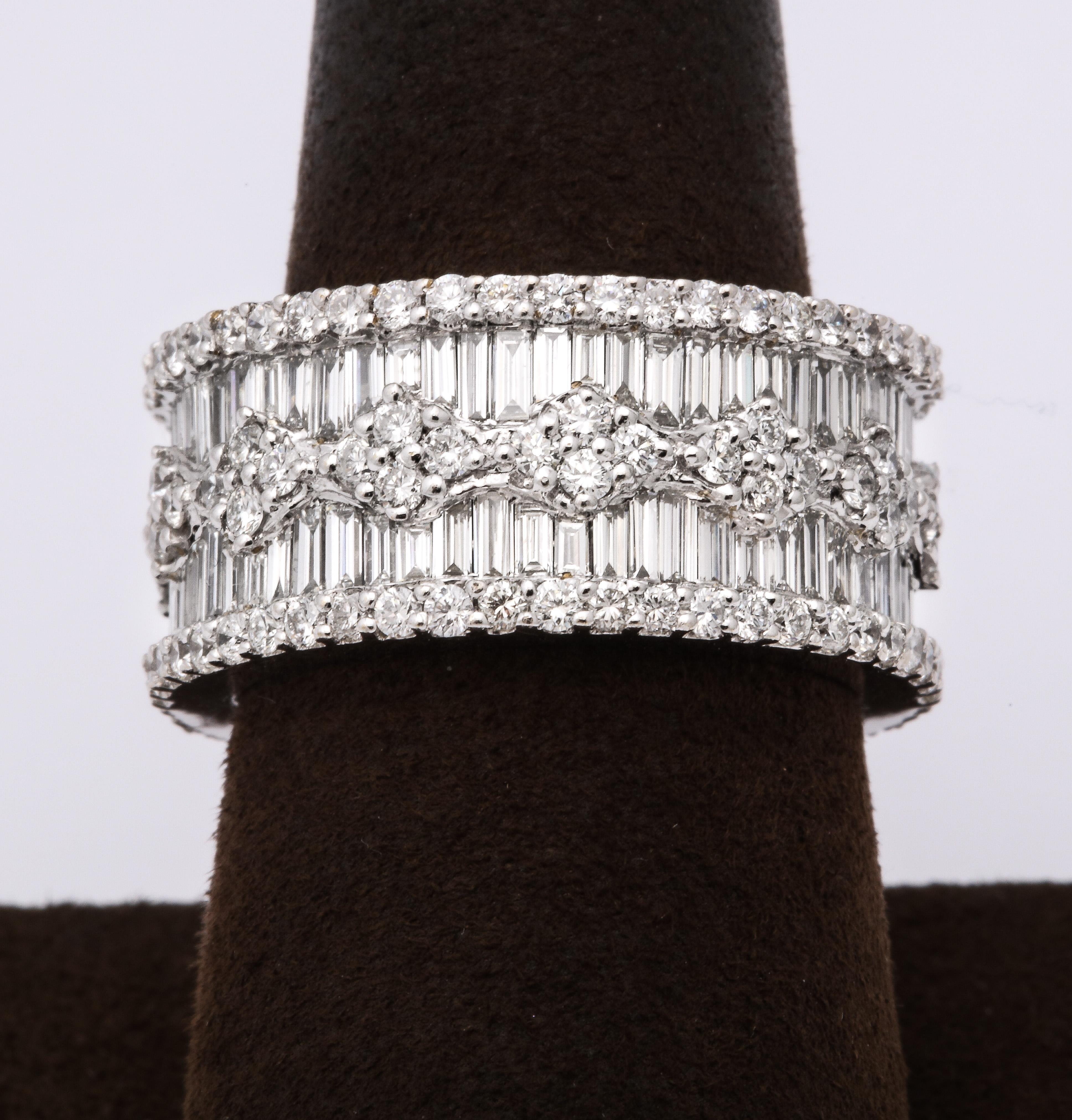 
5.31 carats of white round brilliant cut and baguette diamonds set in 18k white gold.

10.5 mm wide

Size 6.75 -- the size is slightly adjustable.  