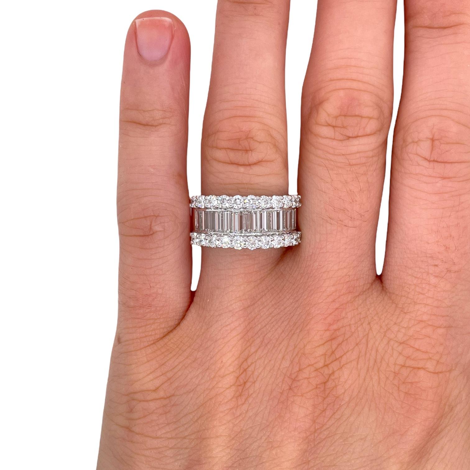 Ring contains baguette and round brilliant diamonds going half way down, totaling 2.70cts. 
Diamonds are near colorless and SI1 in clarity. All stones are mounted in a handmade channel and prong setting in 18k white gold. Ring is a size 6.25. If