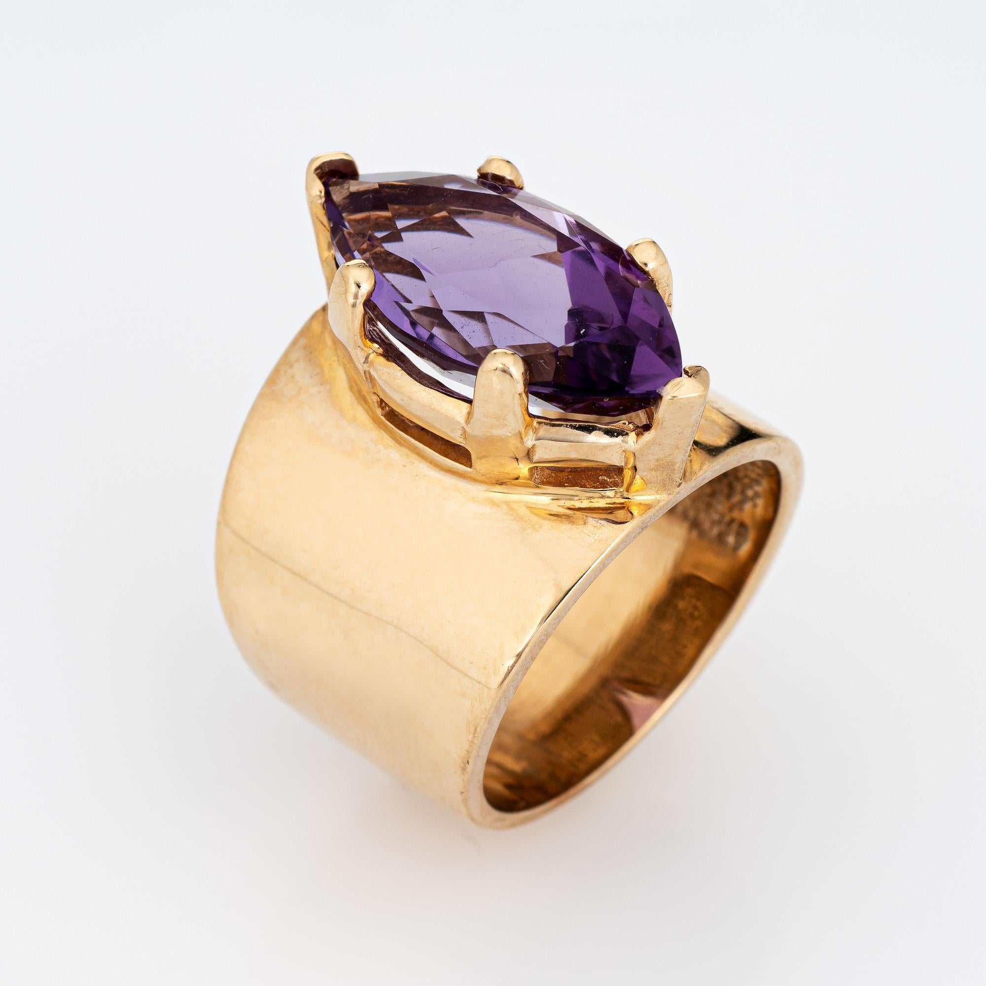Stylish vintage marquise cut amethyst wide band ring (circa 1970s) crafted in 10 karat yellow gold. 

Marquise cut amethyst measures 20mm x 9mm (estimated at 6 carats). The amethyst is in very good condition and free of cracks or chips. 

The royal