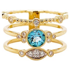 Bague à large anneau avec trois rangées de perles en or jaune 14 carats et topaze bleue ronde