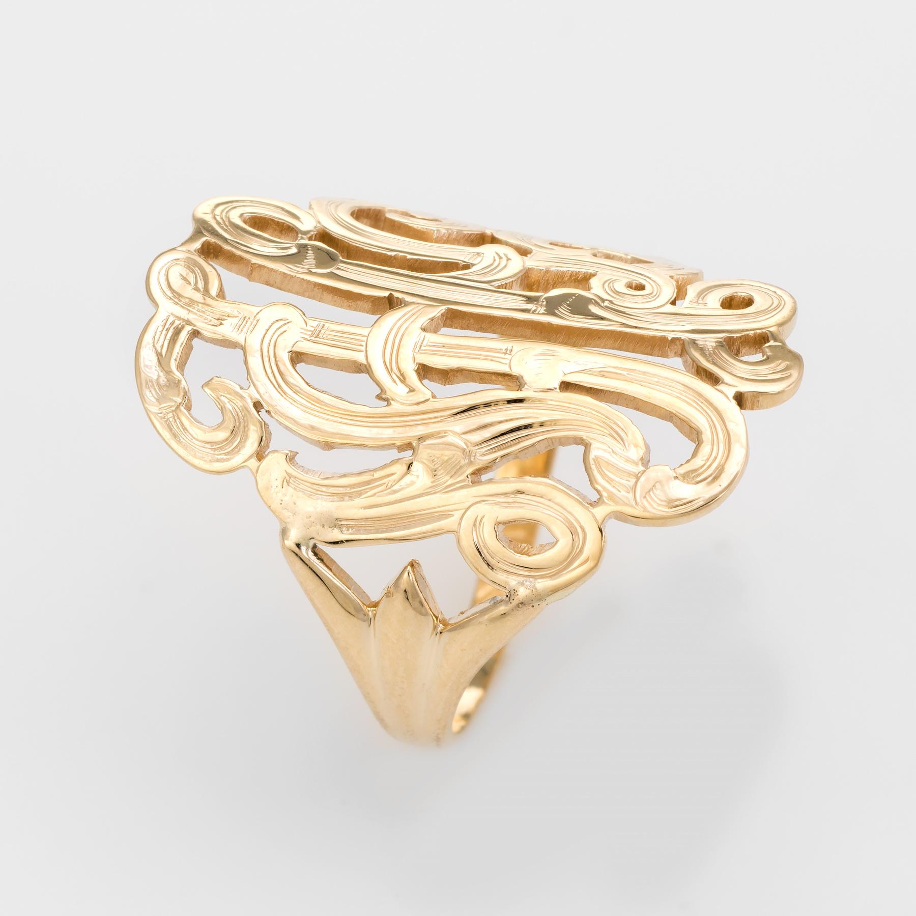 Finely detailed wide band ring (circa 1960s to 1970s), crafted in 14 karat yellow gold. 

The wide (1 inch) mount features a bold and distinct scrolled design. The ring sits flat on the finger.

The ring is in excellent condition.