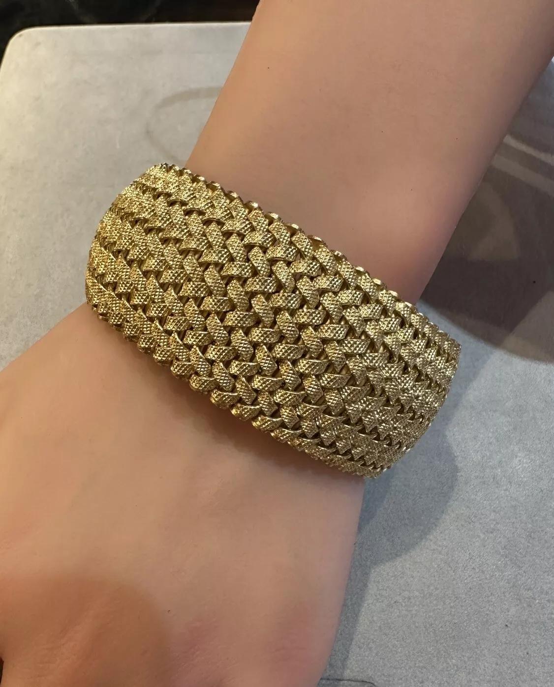 Wide Woven Italian 18k Yellow Gold Bracelet by Giovanni Marchisio

Wide 18k Yellow Gold Bracelet features multiple woven braids of 18k Yellow Gold in a slightly domed design made by Italian designer
Giovanni Marchisio. The bracelet is secured by a
