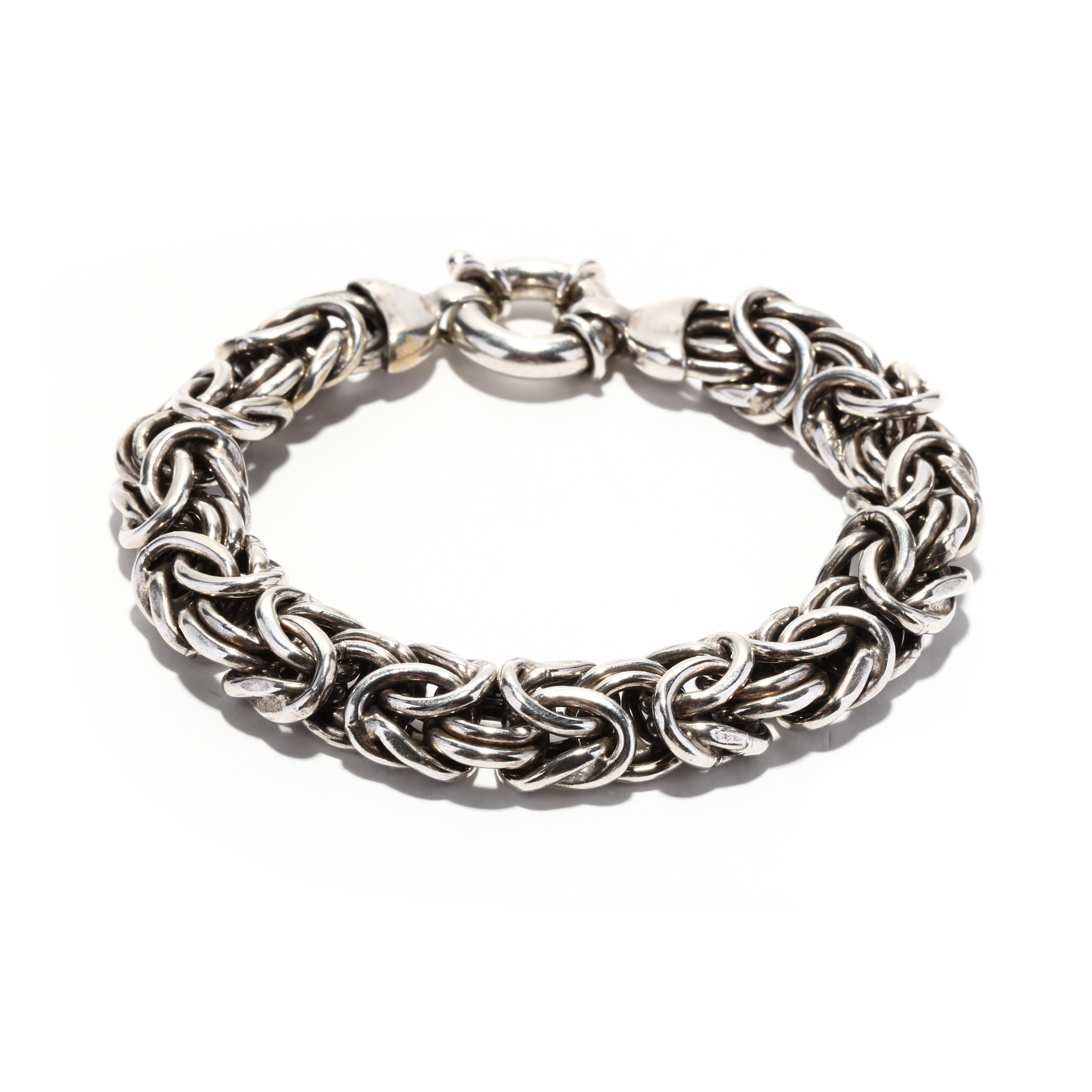 A vintage sterling silver wide byzantine link bracelet. This wide silver bracelet features a woven byzantine link with an oversized spring ring clasp.

Length: 7.25 in.

Width: 7/16 in.

Weight: 21.9 dwts. / 34 grams

Stamps: 925 ITALY

Ring Sizings