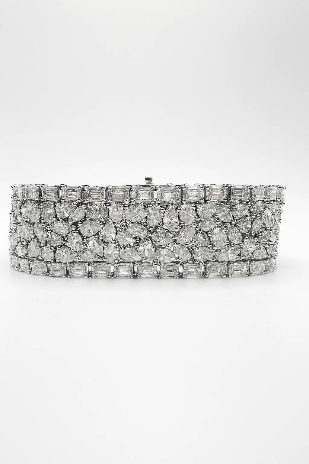 This breathtaking diamond bracelet is a true statement of opulence and craftsmanship. Set in 18K white gold, it features an extraordinary 40.05 carats of diamonds meticulously arranged to create maximum brilliance and fire. Designed in a wide,
