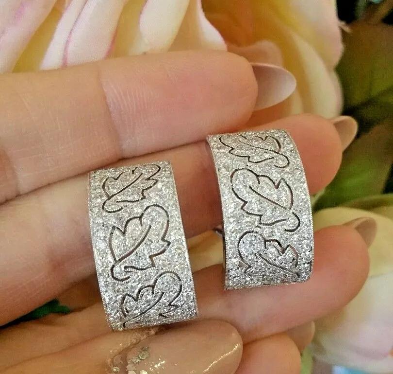 Wide Diamond Hoop Leaf Motif Earrings in 18k White Gold

Diamond Hoop Earrings with Leaf Design in 18k White Gold
Features:

3.00 carats total weight of Round Brilliant Diamonds
Cut-out Leaf Design

Earrings measure 0.93 inch long and .50 inch