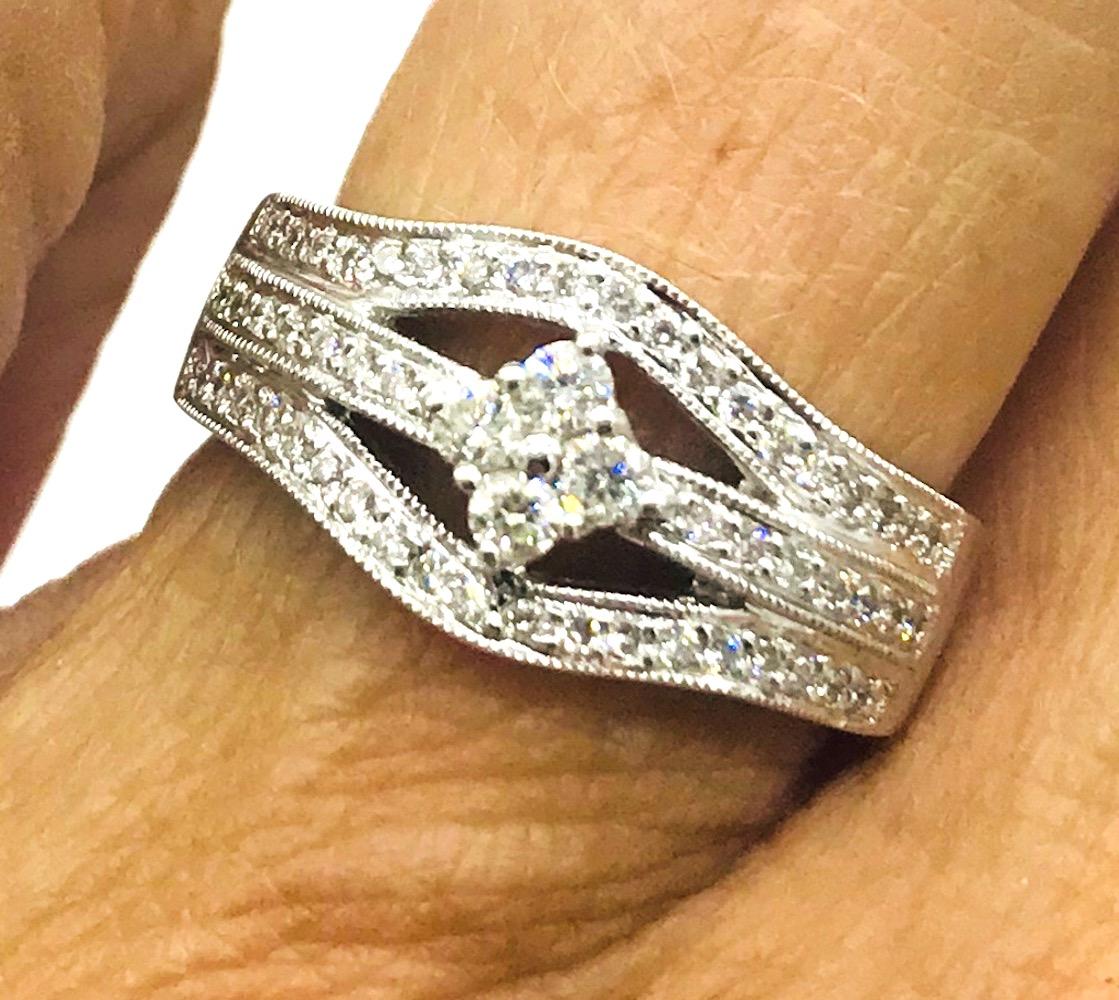The triple wide diamond band, Cluster .55CT Diamond 18Kt white gold Ring
Wide 10.16 mm at the top is made from a triple band consisting of  (36) pave diamonds. The total weight of .55 carat of diamonds is set in this pretty ring.
 The quality of