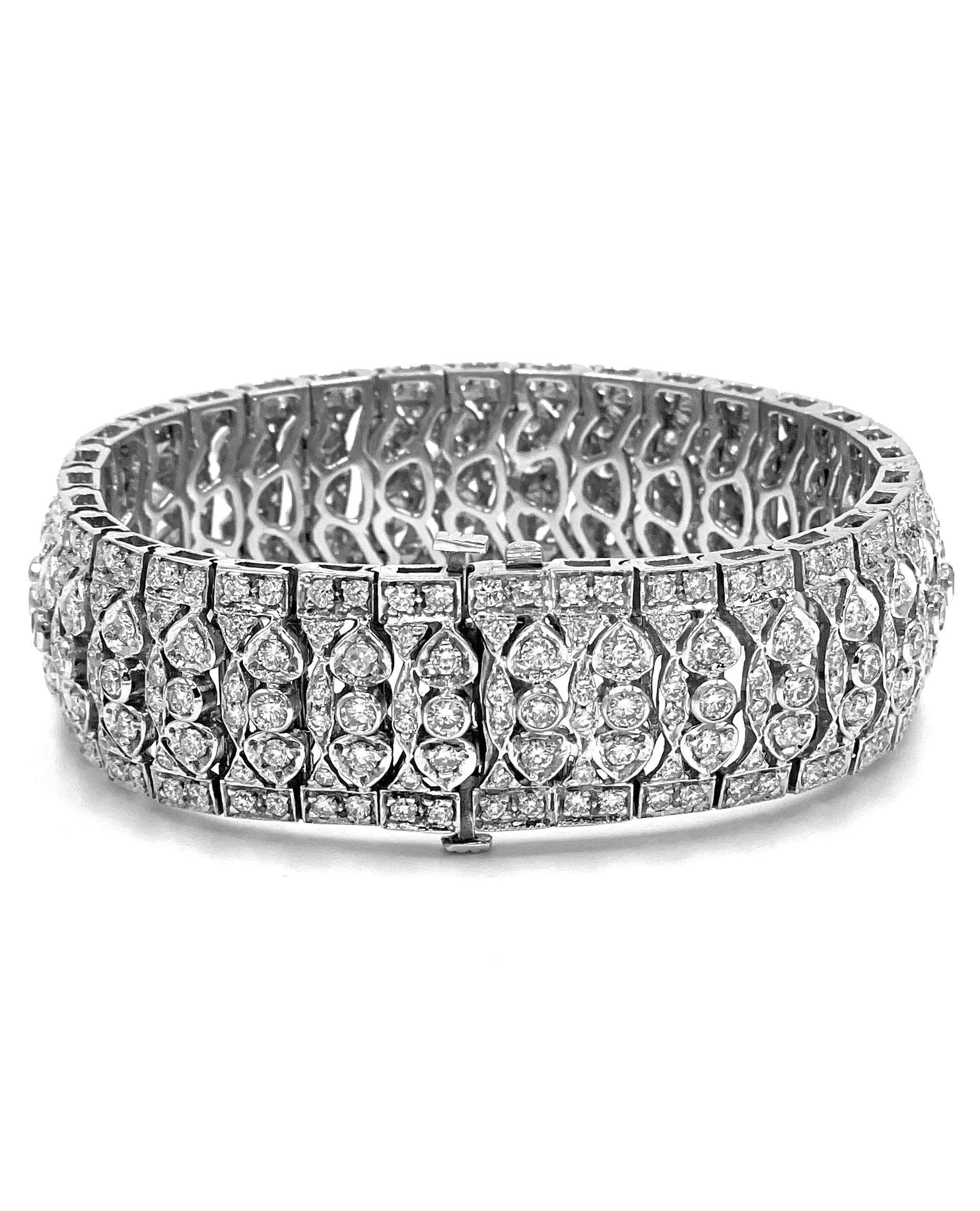 Vintage style with a modern flare, this 18K white gold bracelet features 352 round brilliant-cut diamonds with a total weight of 13.0 carats.  

* Length: 7.25 inches long
* 18.6mm wide
* Diamonds are G/H color, VS2/SI1 clarity.
* Diamonds are pave