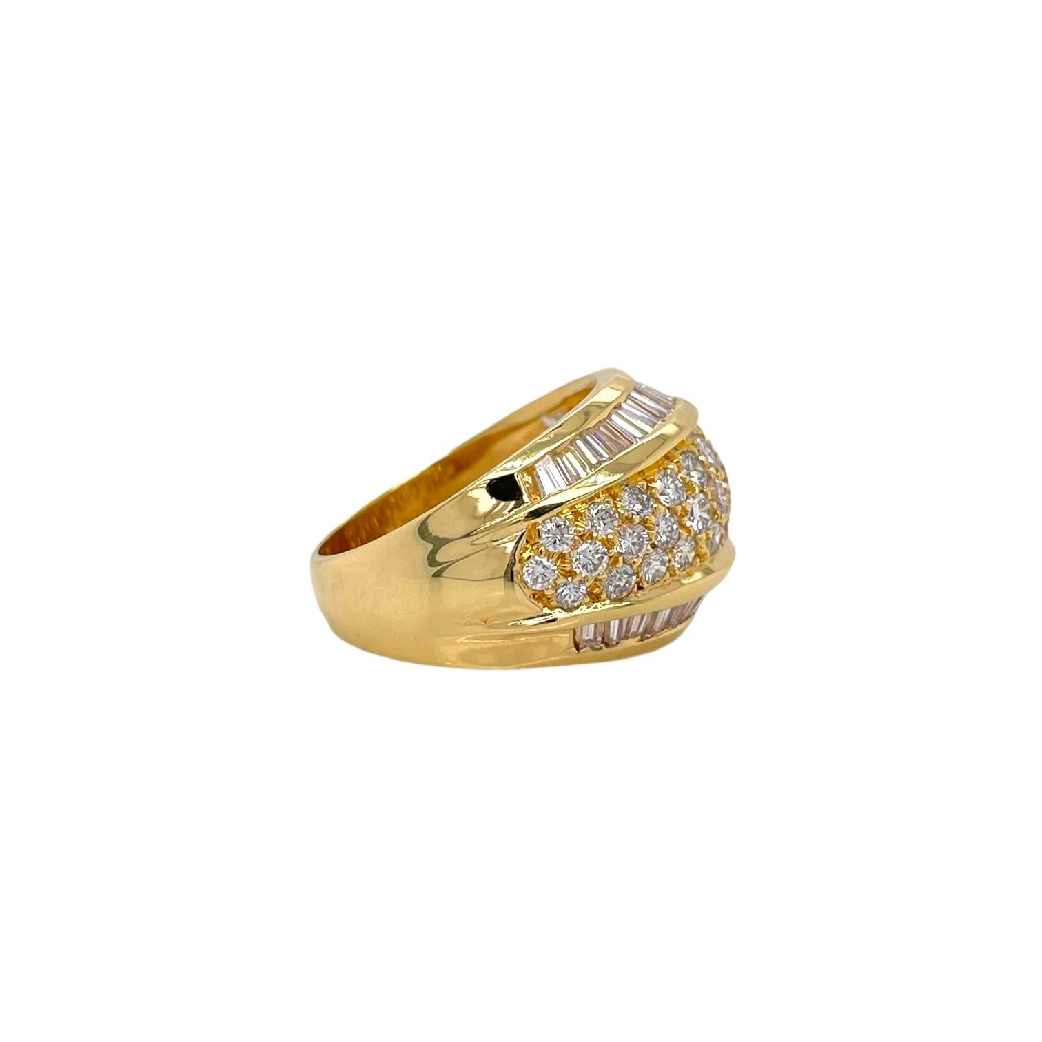 Beautiful 14mm wide domed baguette and round diamond cocktail ring. Ring contains baguette diamonds within a channel setting, 1.38tcw and round brilliant diamonds within prong settings, 1.30tcw. All diamonds are G in color and SI1 in clarity,