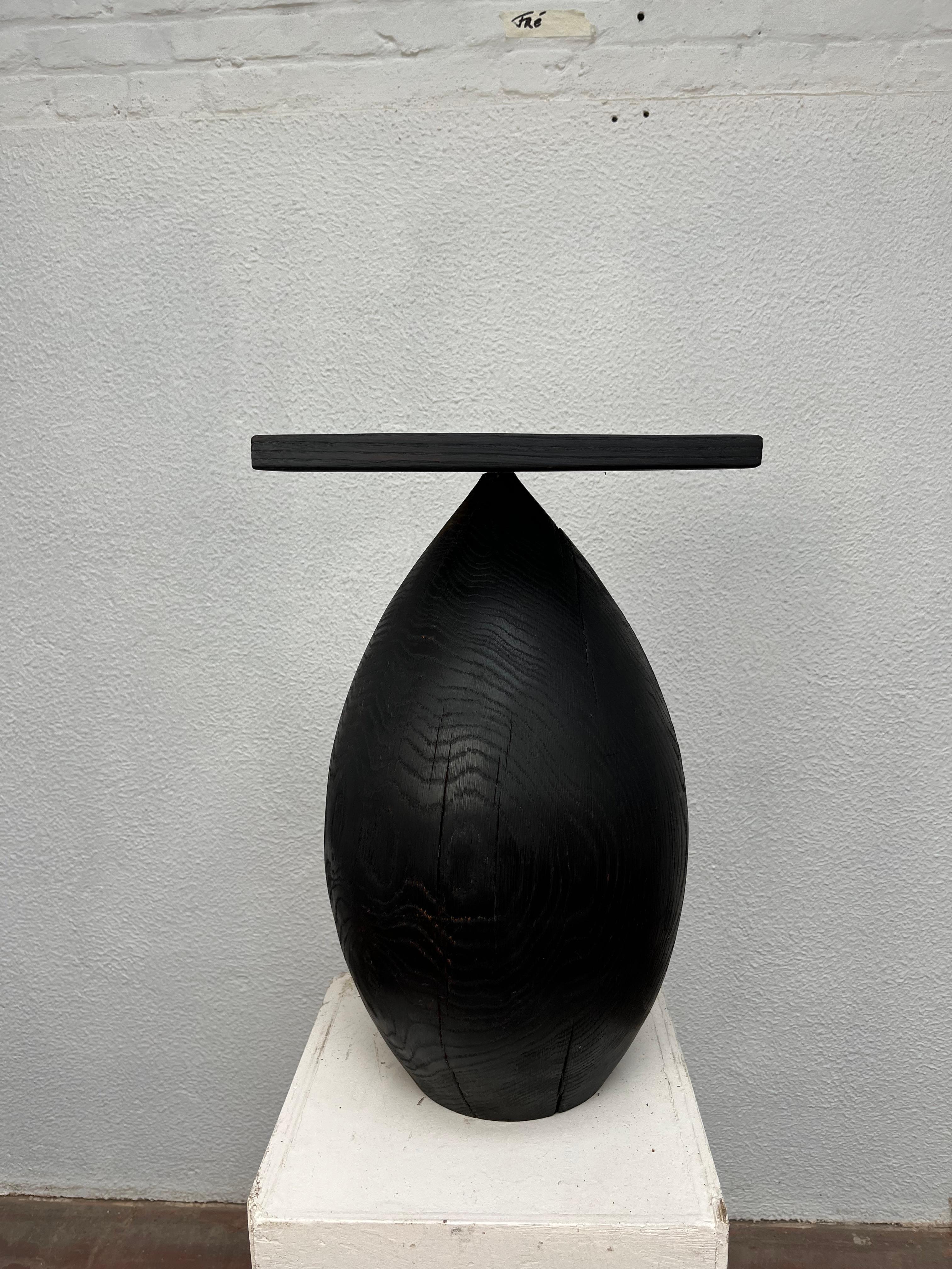 Wide Dropseat by Frederik Van Humbeeck
Dimensions: W 30 x D 30 x H 55 cm
Materials: Wood.
Weight: 17,4 kg

Variations by woodspecies: Sharred Oak, Oak, Cherry, European walnut, American Walnut, Chesnut.

With the Drop Seats, Frederik explores the