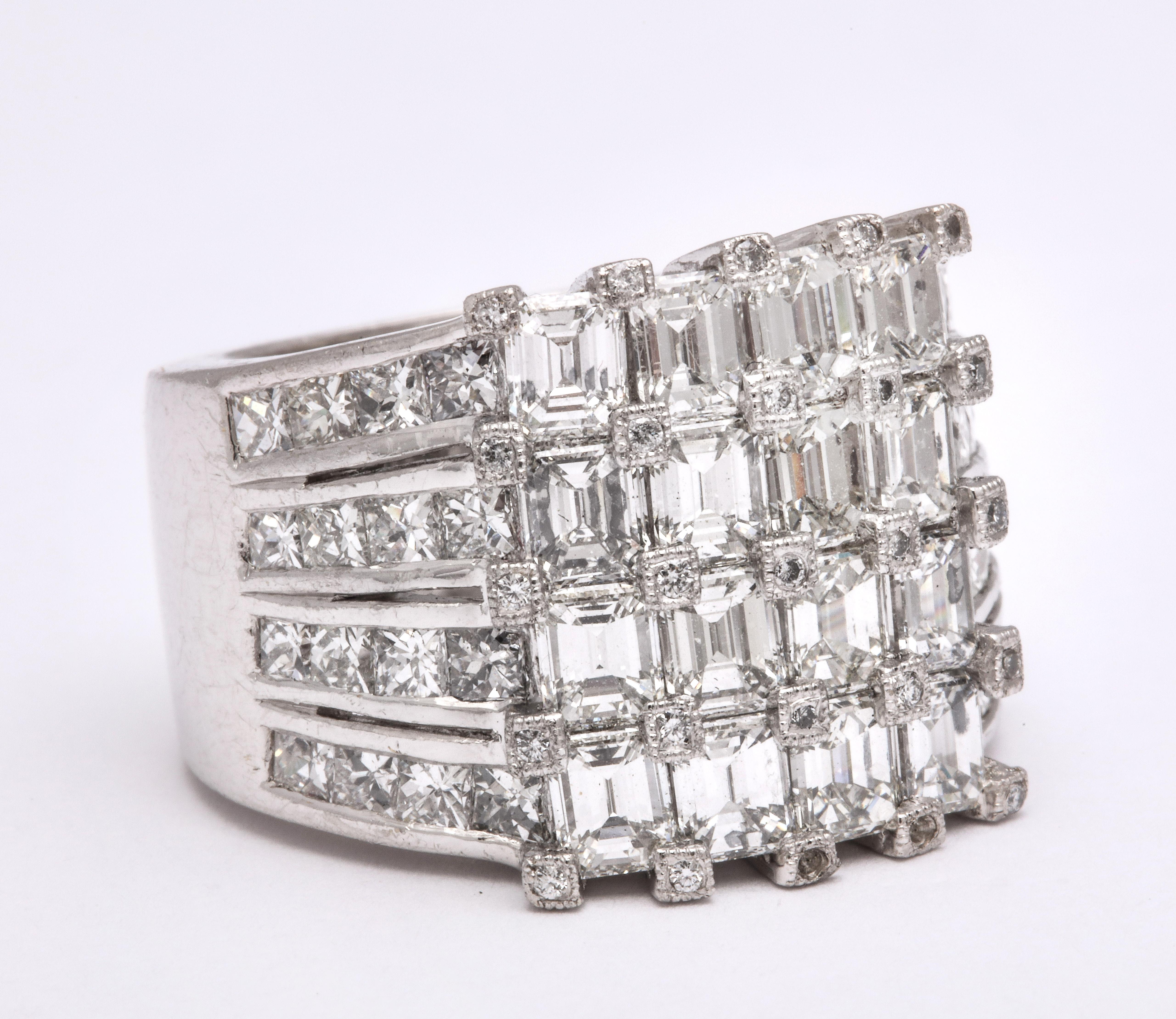 
A FABULOUS PIECE! 

7.18 carats of white Emerald cut and channel set Princess cut diamonds set in platinum. 

Small white round brilliant cut diamonds cover each prong -- tons of sparkle in a unique design!

Currently a size 7.5, this ring is