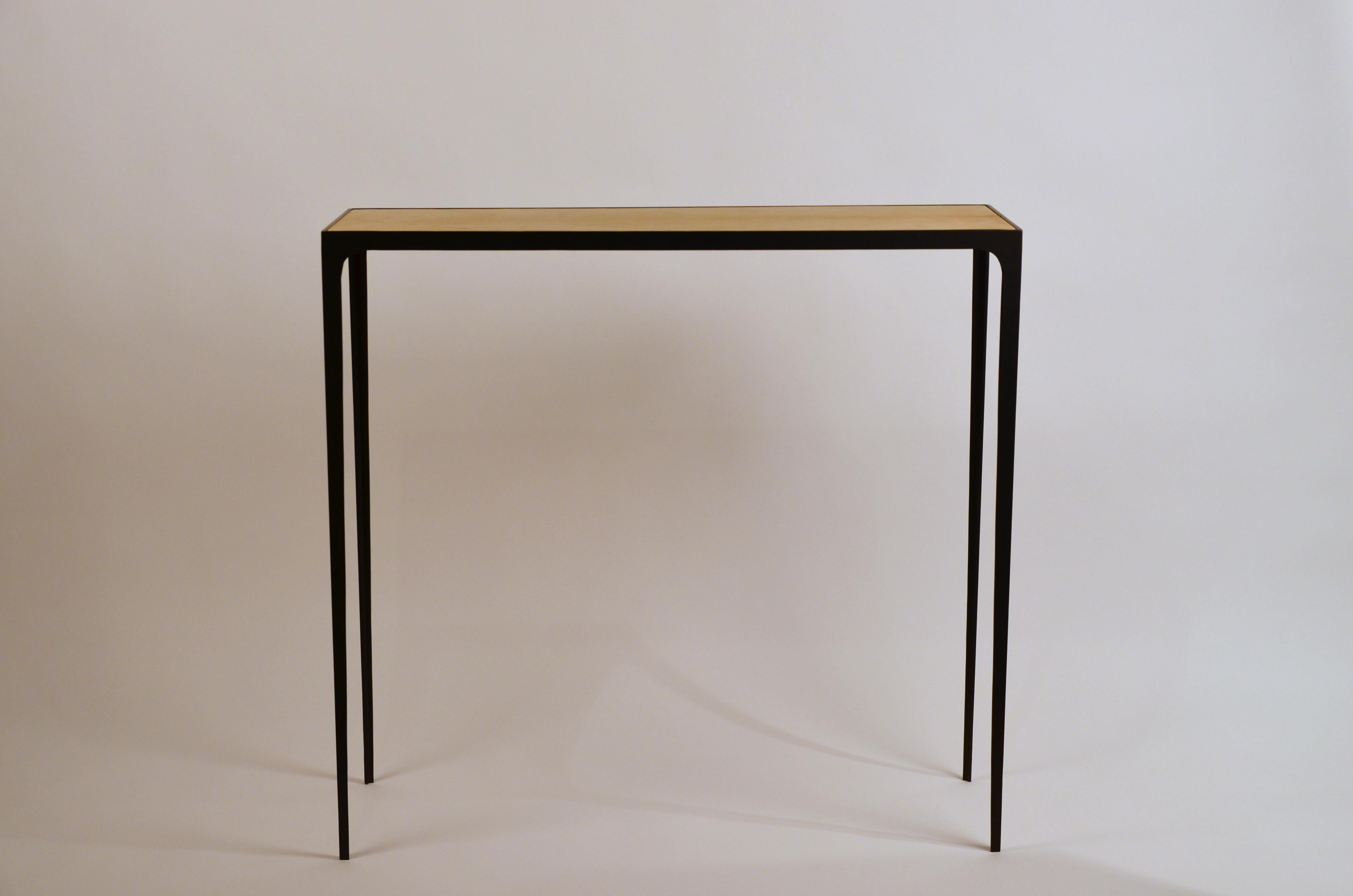 Wide 'Esquisse' natural parchment and wrought iron console by Design Frères.

Chic handmade natural parchment top paired with a slender blackened wrought iron base.