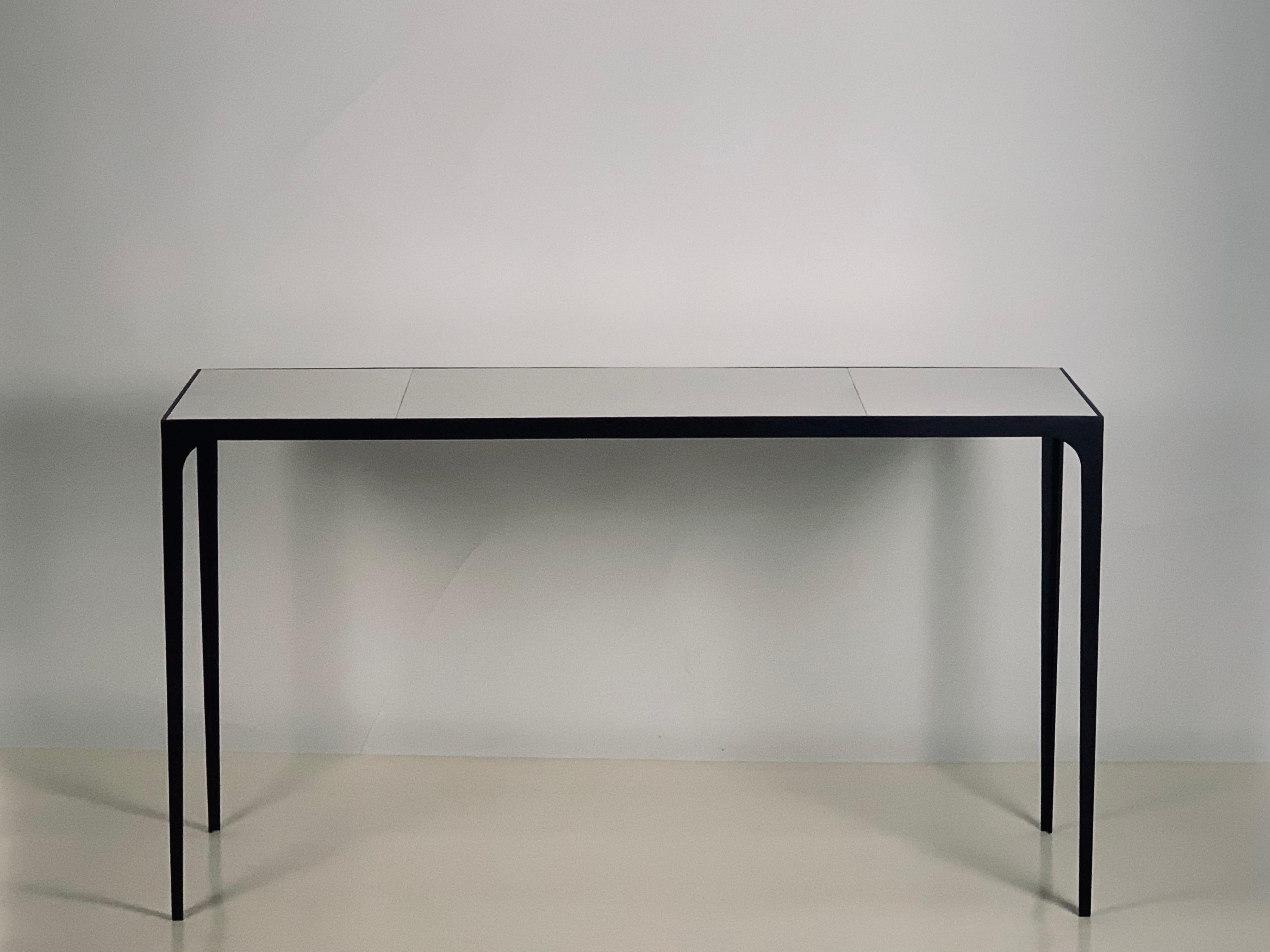 Wide 'Esquisse' parchemin console or library table from our exclusive Design Frères line. Chic combination of a slender blackened iron base with an inset goatskin (parchemin) clad top. Impressive proportions. Understated elegance. Timeless.