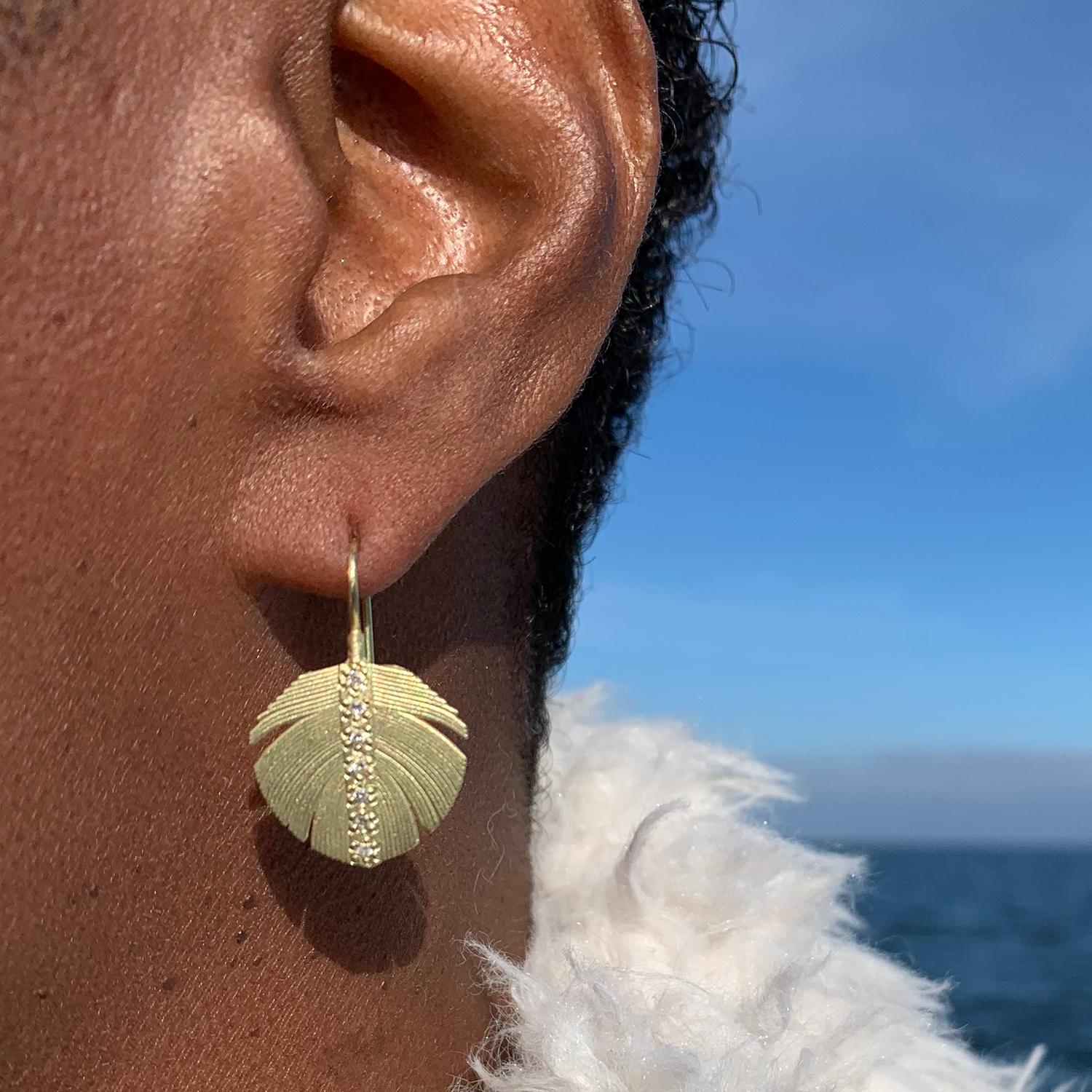 These lovely earrings are perfect for any nature lover, bird watcher, or boho babe!
18k yellow gold feathers with center channels of pave set diamonds hang delicately from 18k yellow gold ear wires. The earrings measure from ear 1