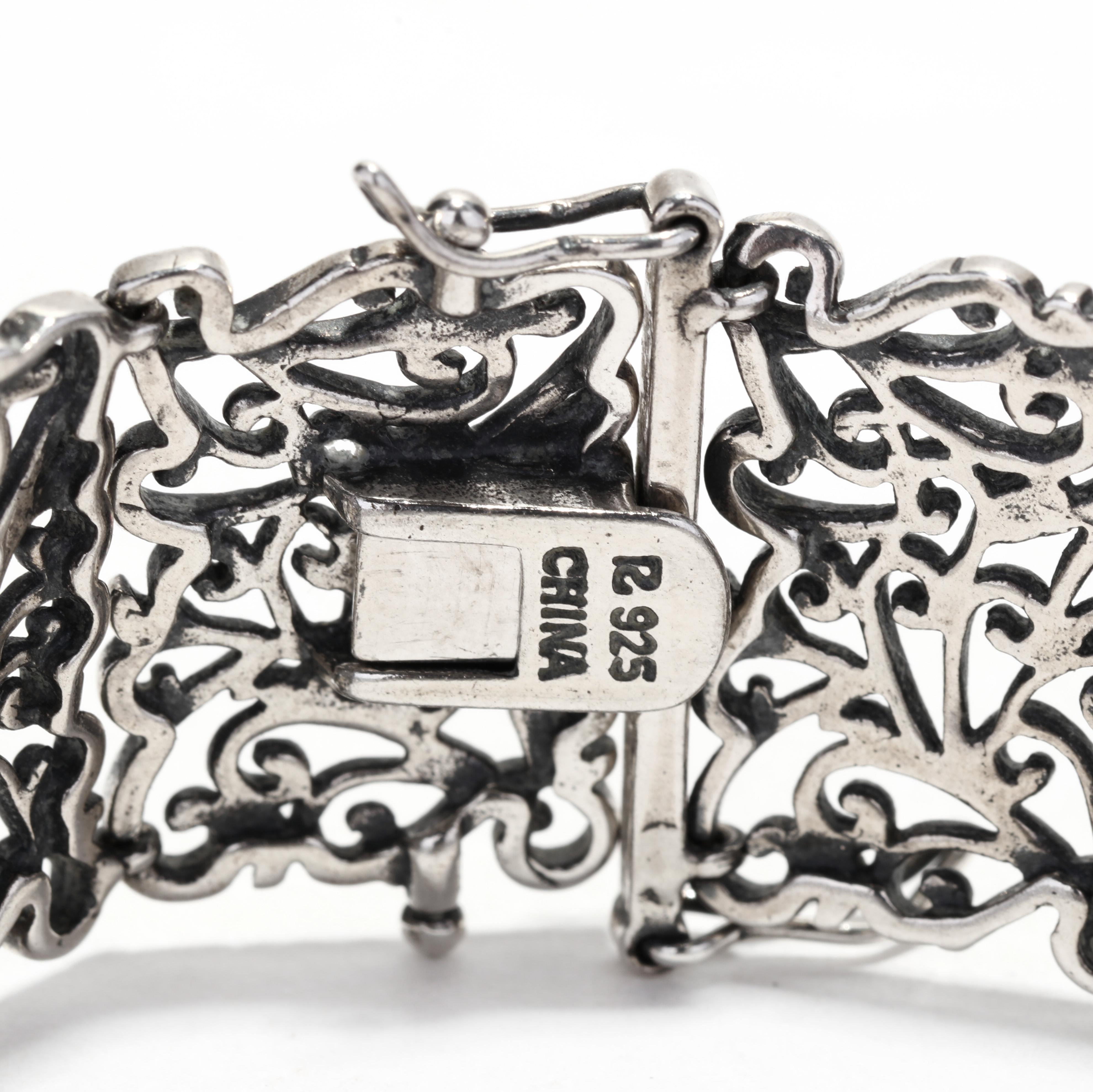 A vintage sterling silver wide filigree bracelet. This wide bracelet features rectangular scroll filigree links and with a box clasp.

Length: 7.25 in.

Width: 3/4 in.

Weight: 17.1 dwts. / 26.6 grams

Stamps: 925 CHINA

Ring Sizings &