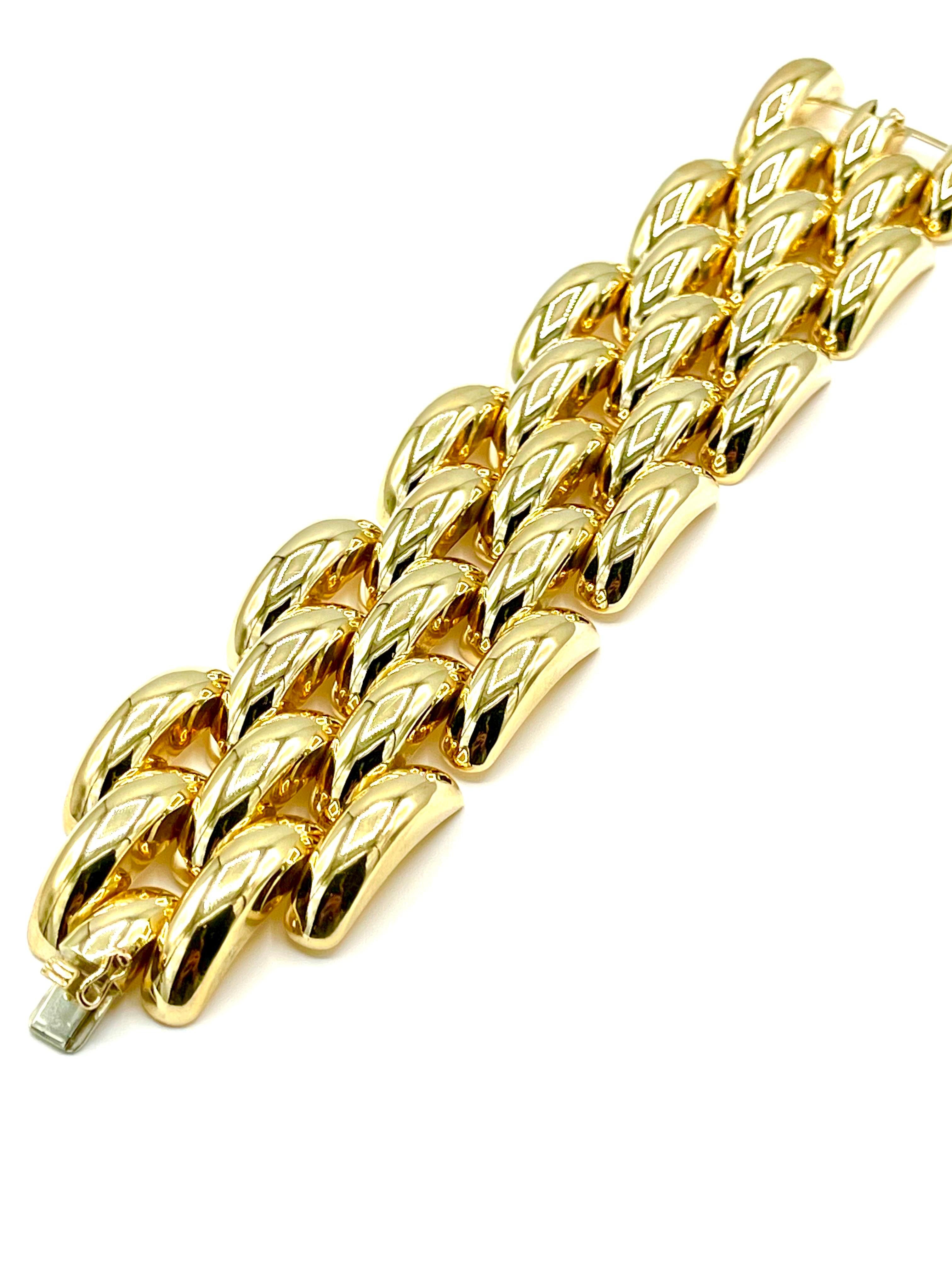 This is a beautiful wide bracelet.  It consists of five rows of links, with a hidden clasp.  The bracelet measures 8.25 inches in length, and 1.60 inches in width, made in 14K yellow gold.  Offered by Charles Schwartz and Son Jewelers.