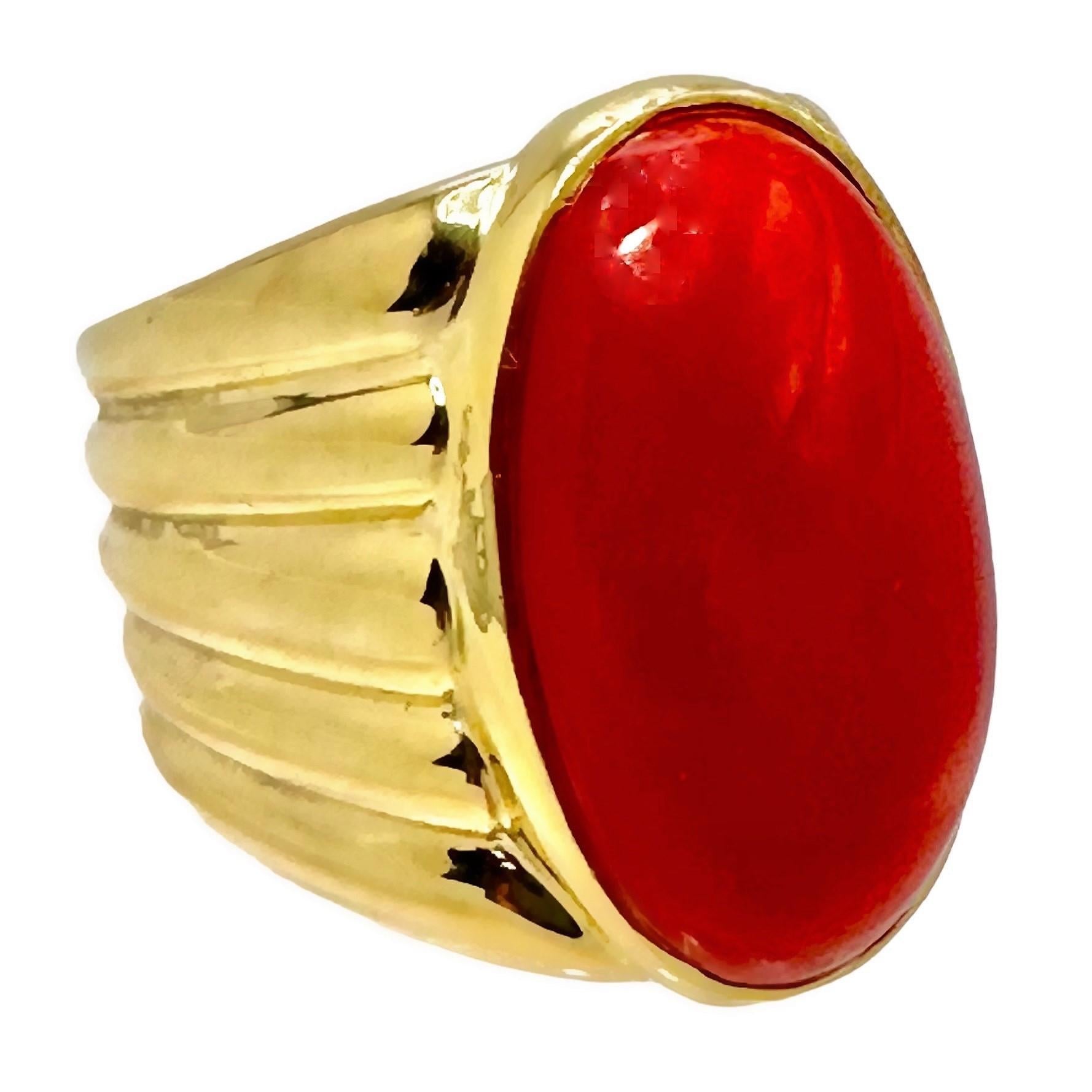 A beautiful late 20th century ring, centered around a deep oxblood red coral measuring approximately 22.5mm by 13mm. With a Doric column inspired design, the wide, fluted shank measures 13/16 of an inch at the shoulders, and 1/3 of an inch at the